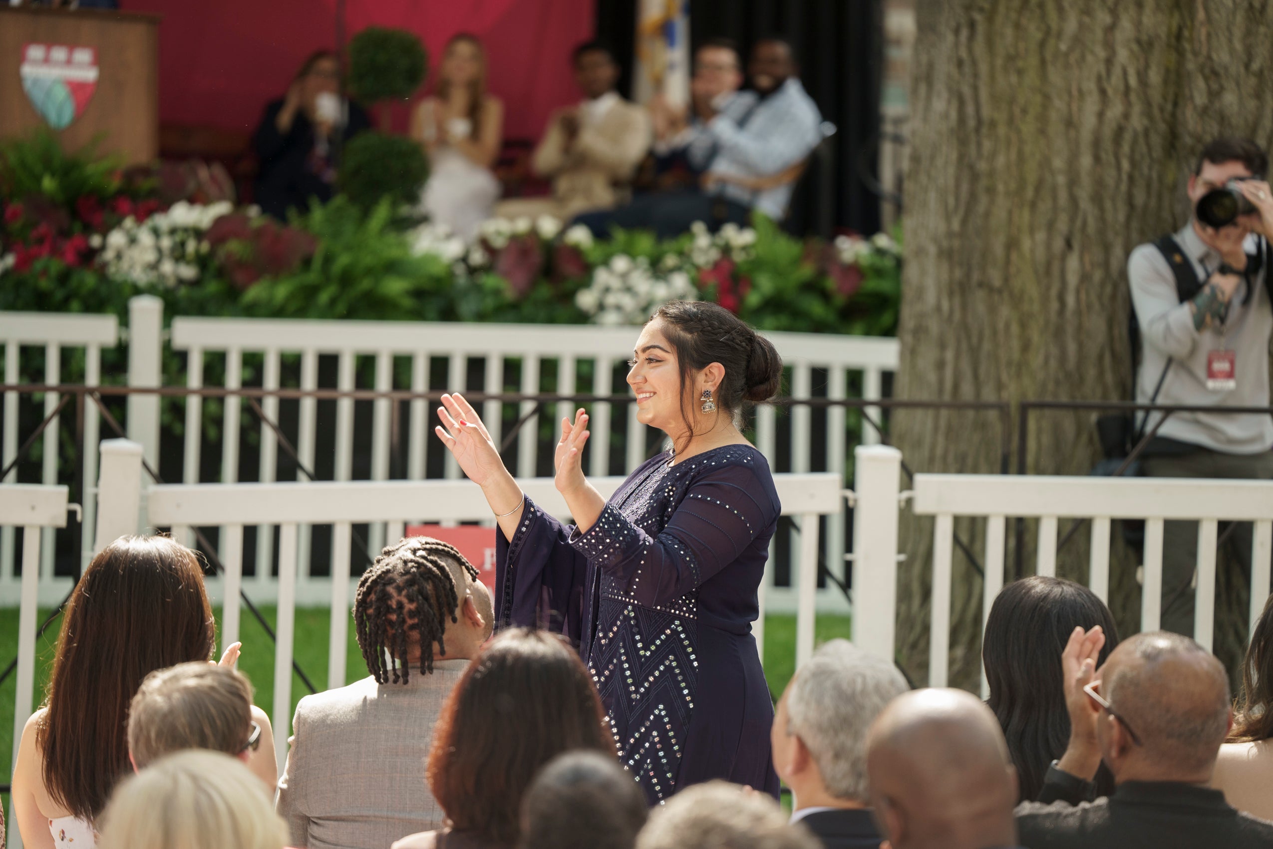 A woman waving to the audience
