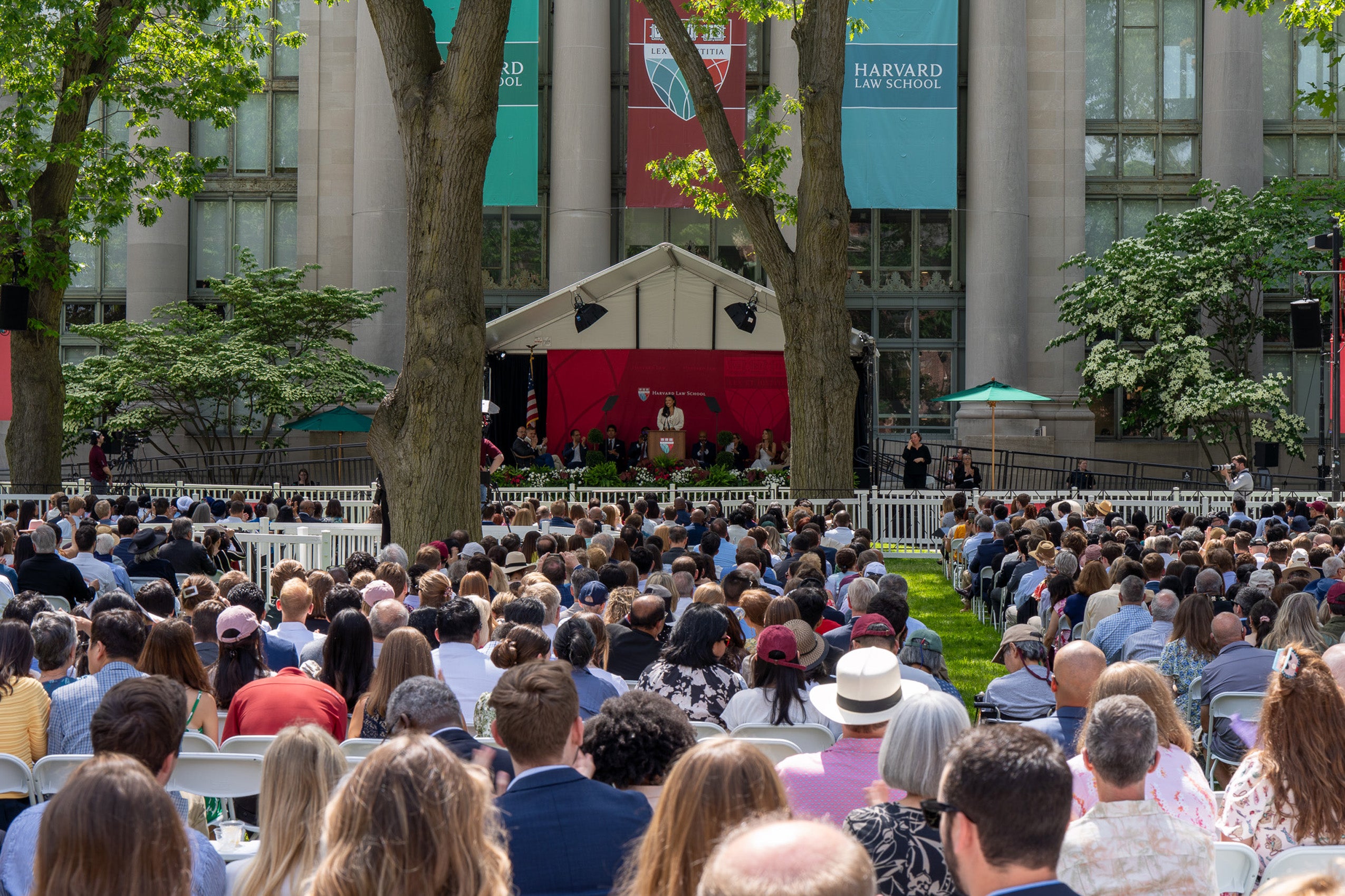A view of the stage in front of a building from behind the audience.