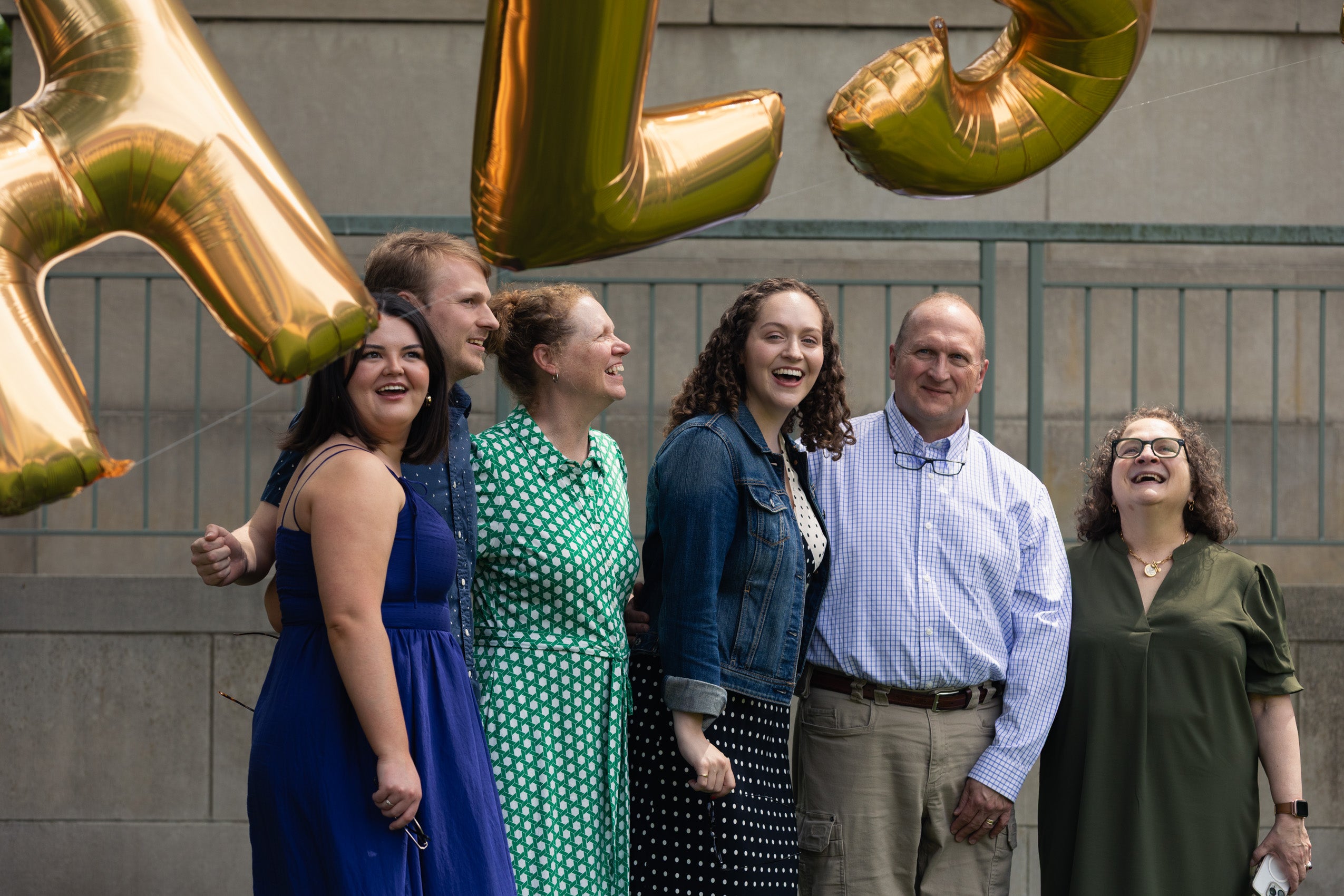 A group of people pose under