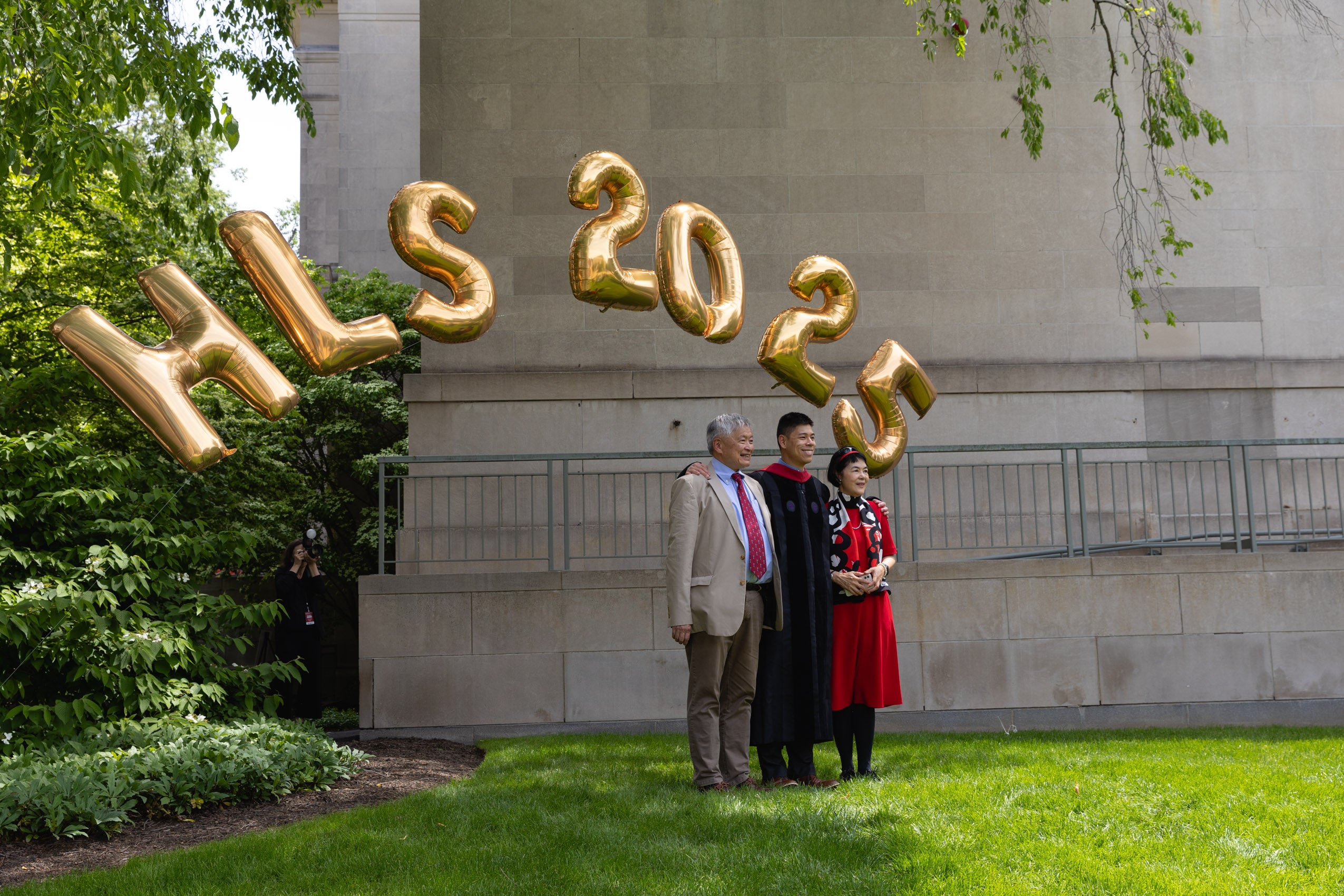 A student and family pose under HLS 2025 balloons.