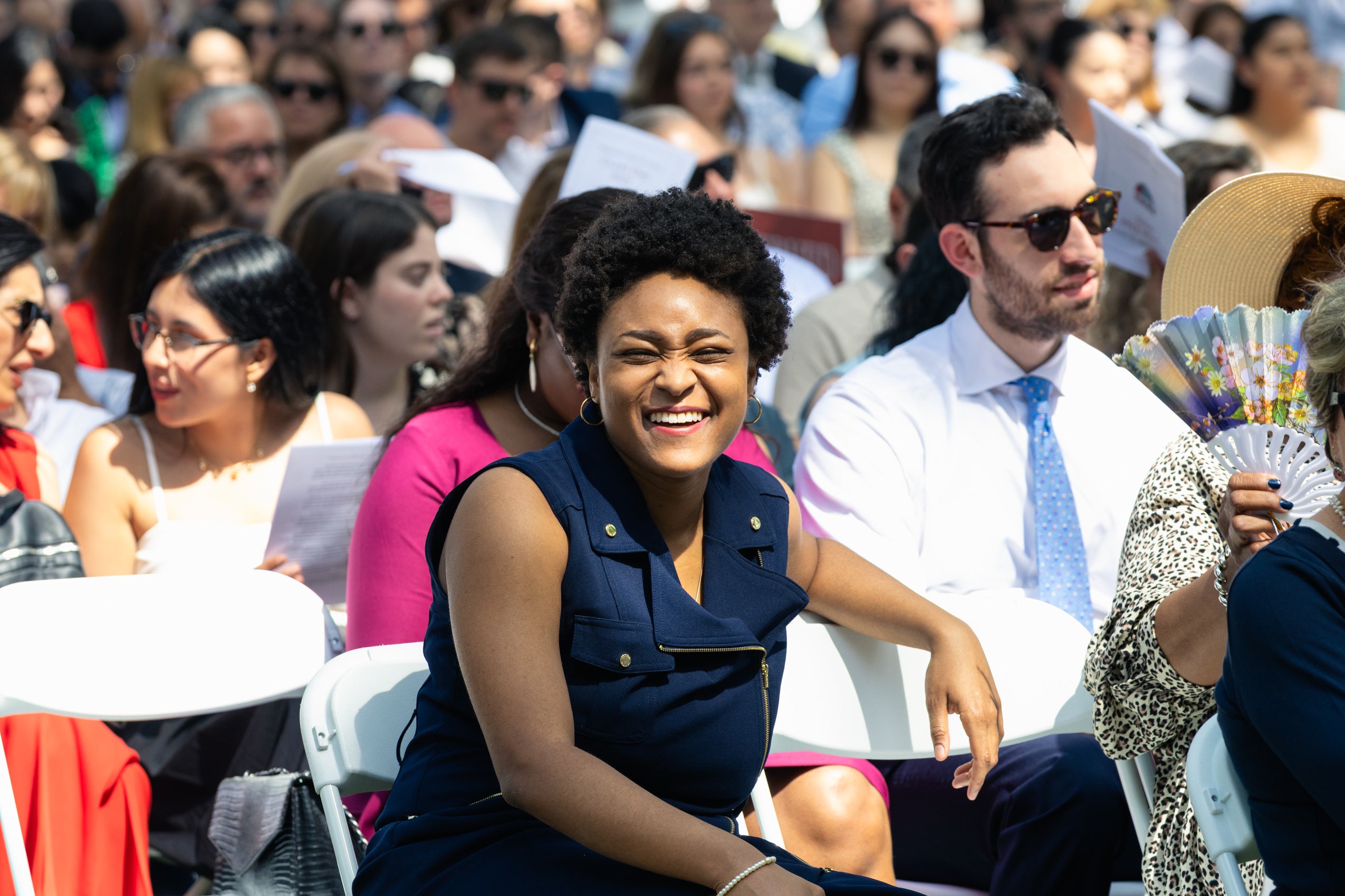 A woman sitting and smiling