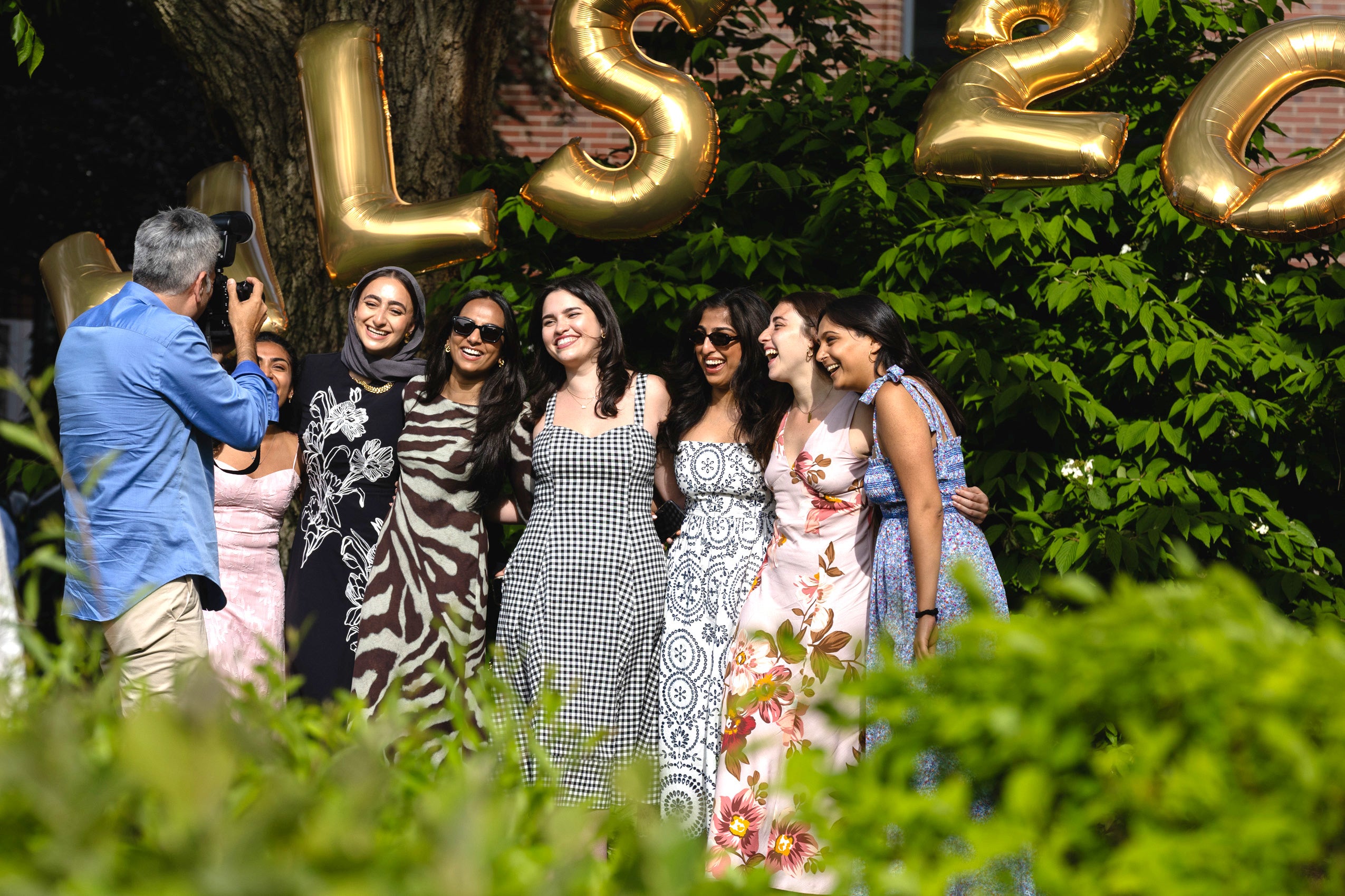 A group of women standing together and smiling