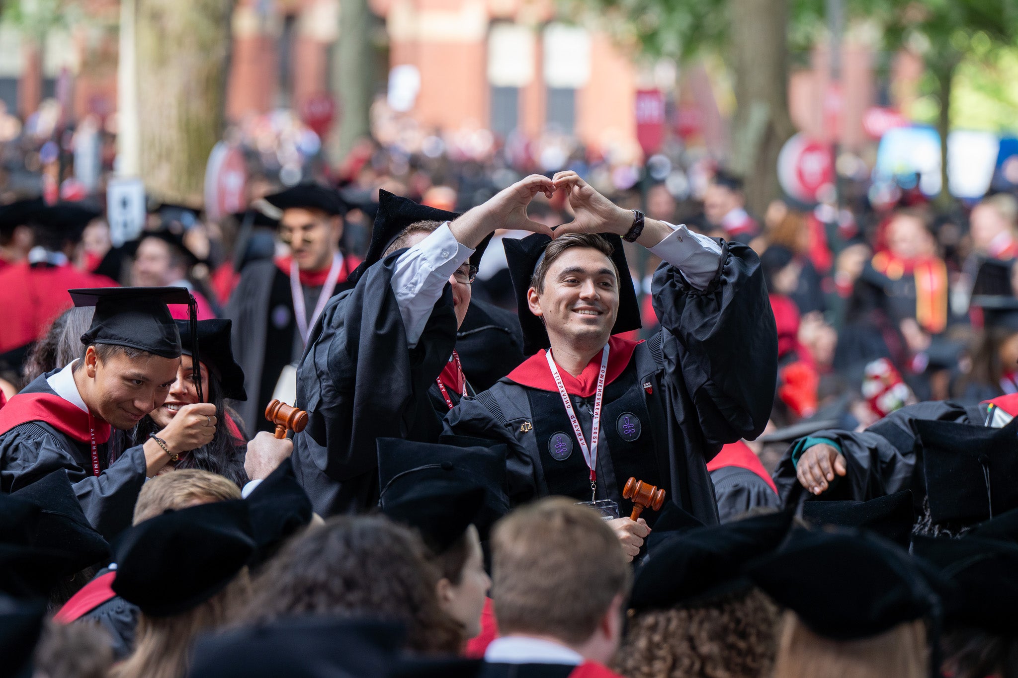 Two students making a heart with their hands