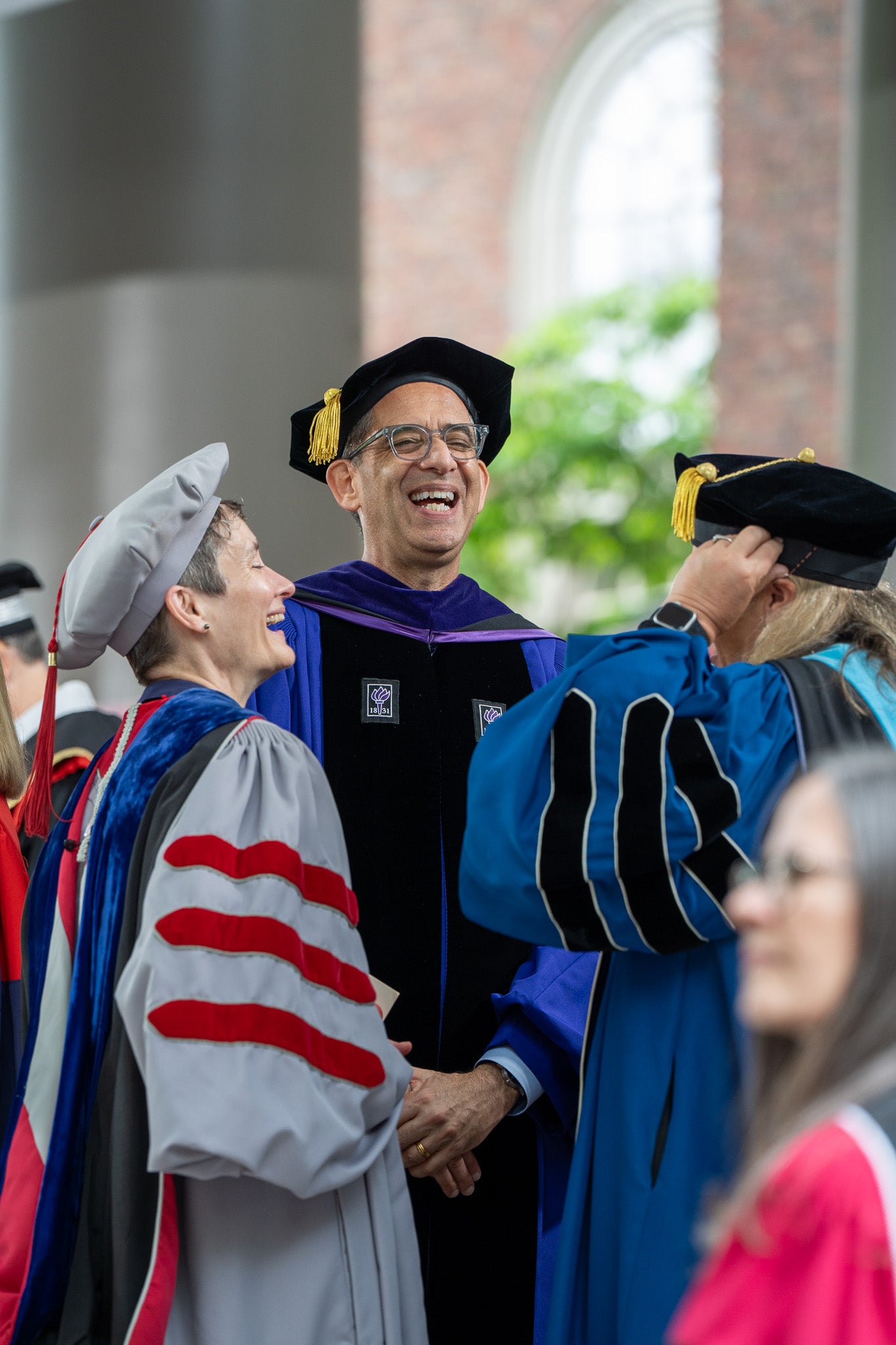 Several Harvard Deans laughing and chatting together