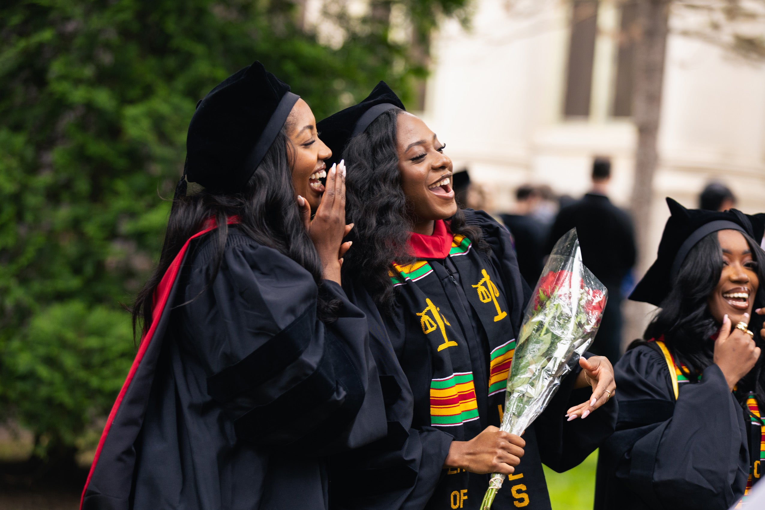 Graduates standing together and laughing