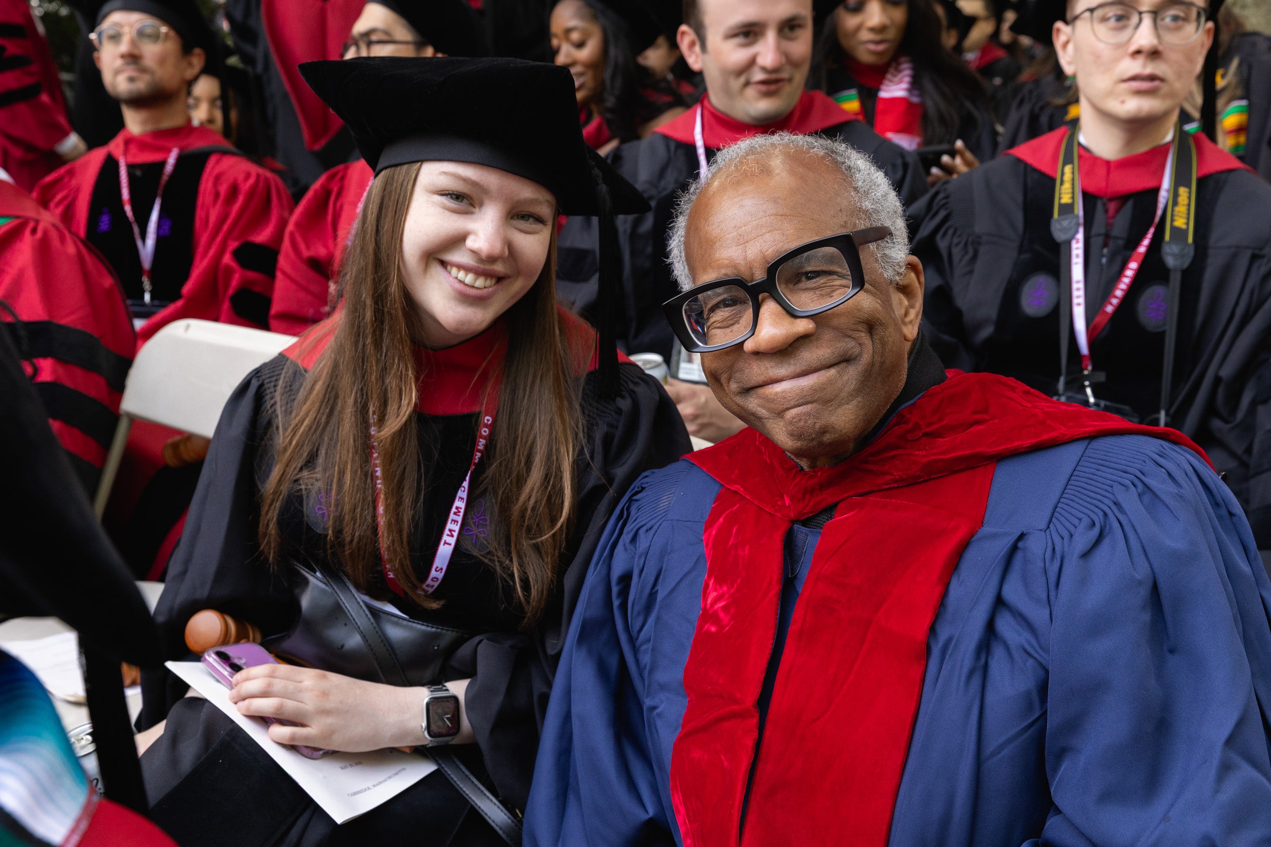 Randall Kennedy sitting and smiling with a graduate