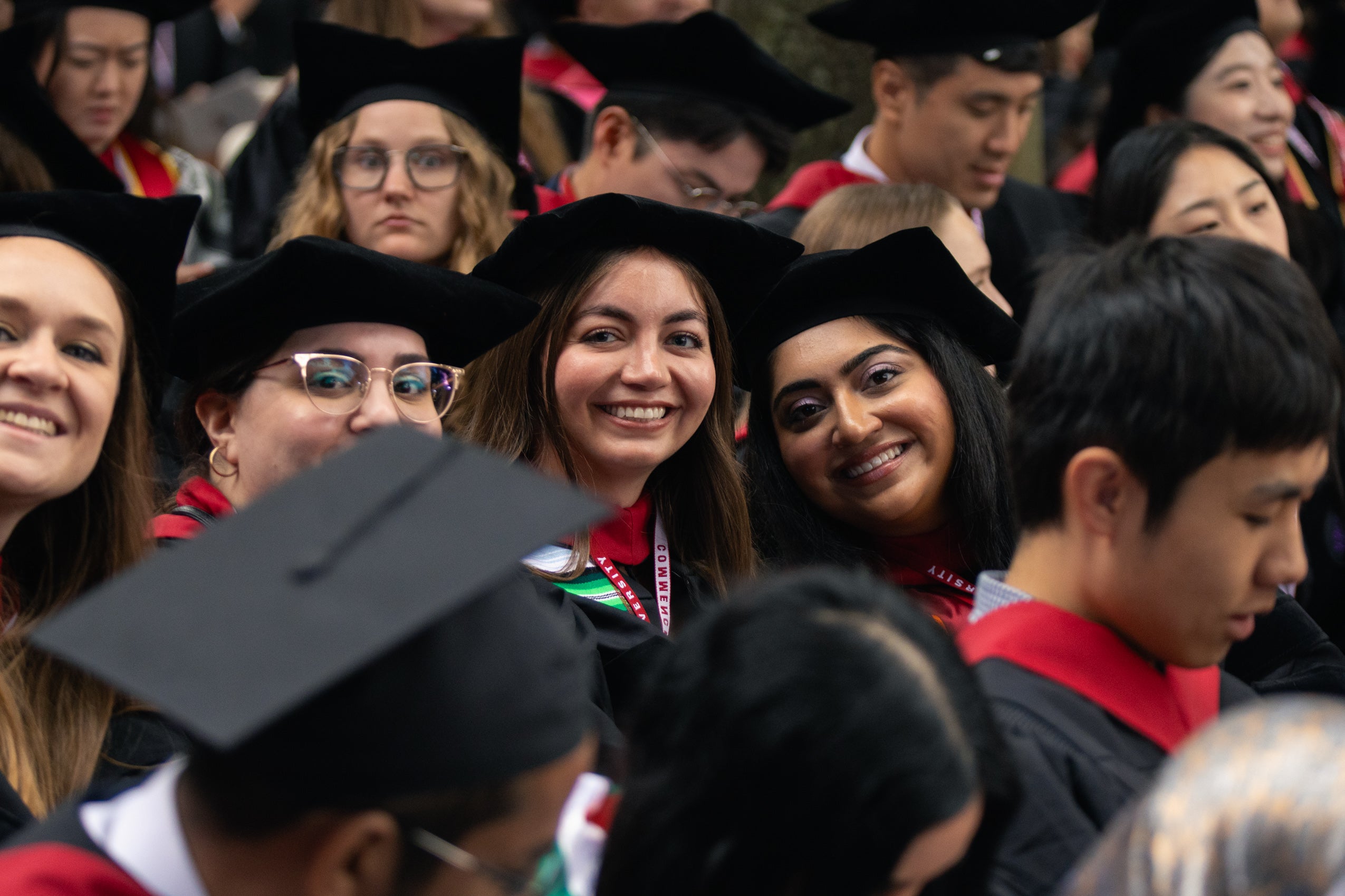 Graduate students seated in the Yard, smiling