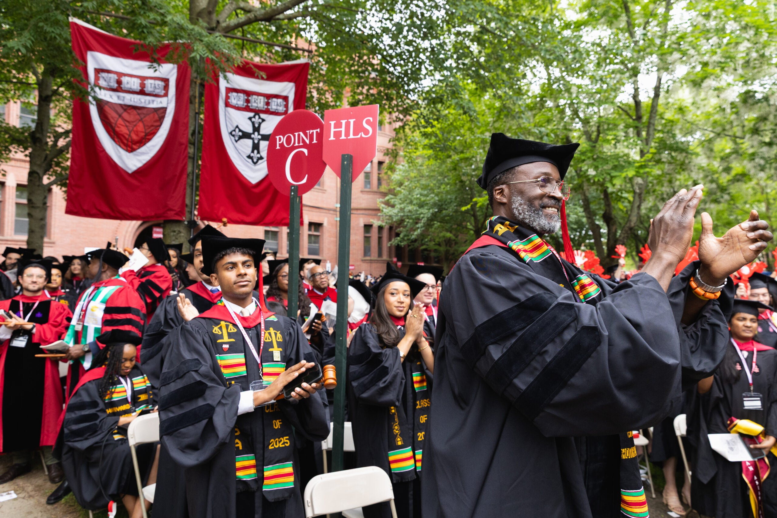 Graduates standing and cheering
