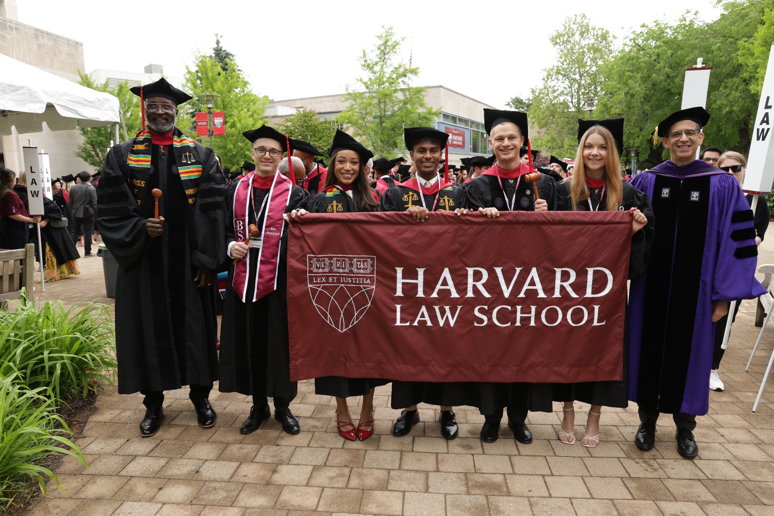 Class marshals hold HLS flag at front of procession
