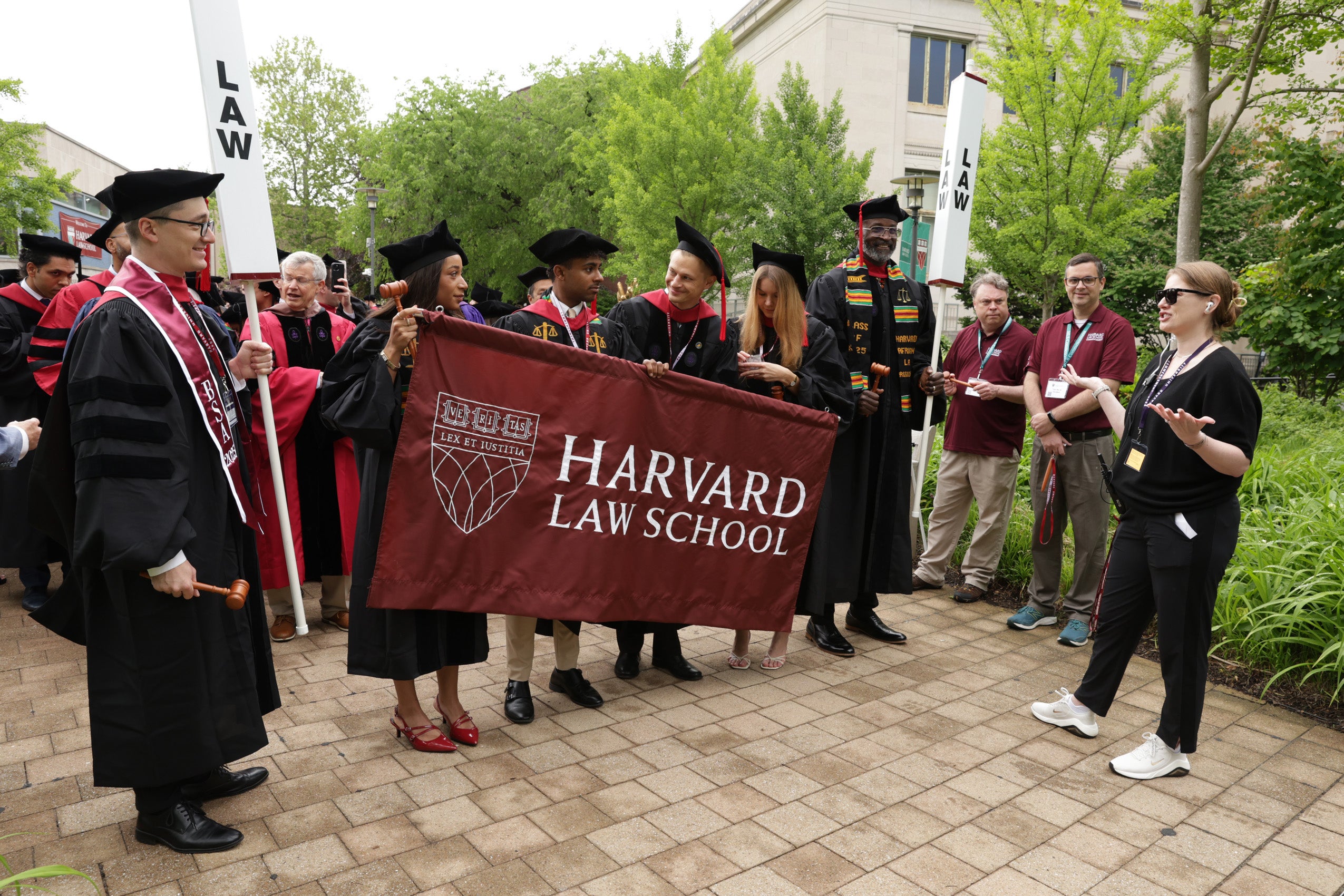 Class marshals hold HLS flag at front of procession