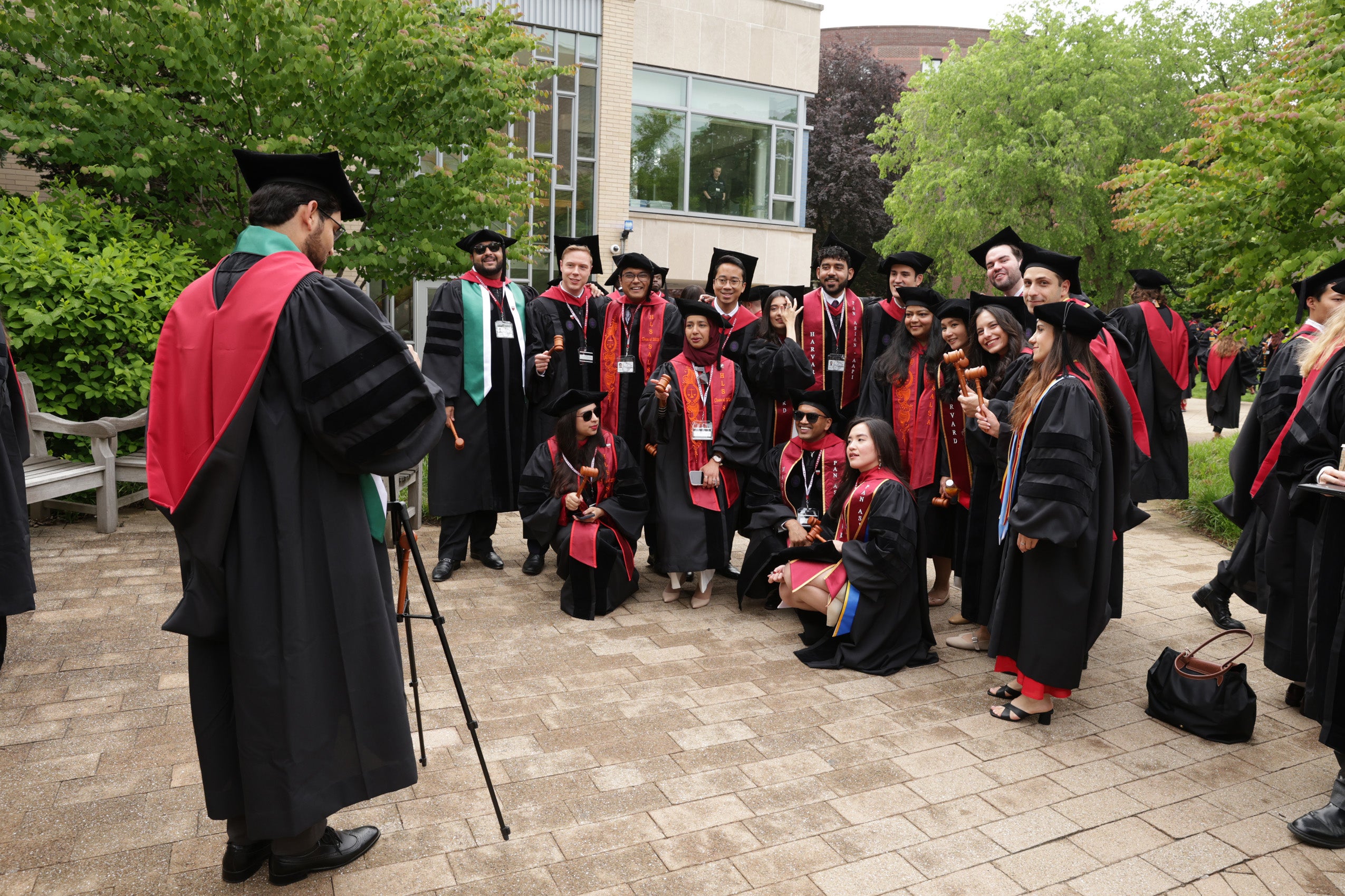 A group of graduates pose for a photo with their gavels.
