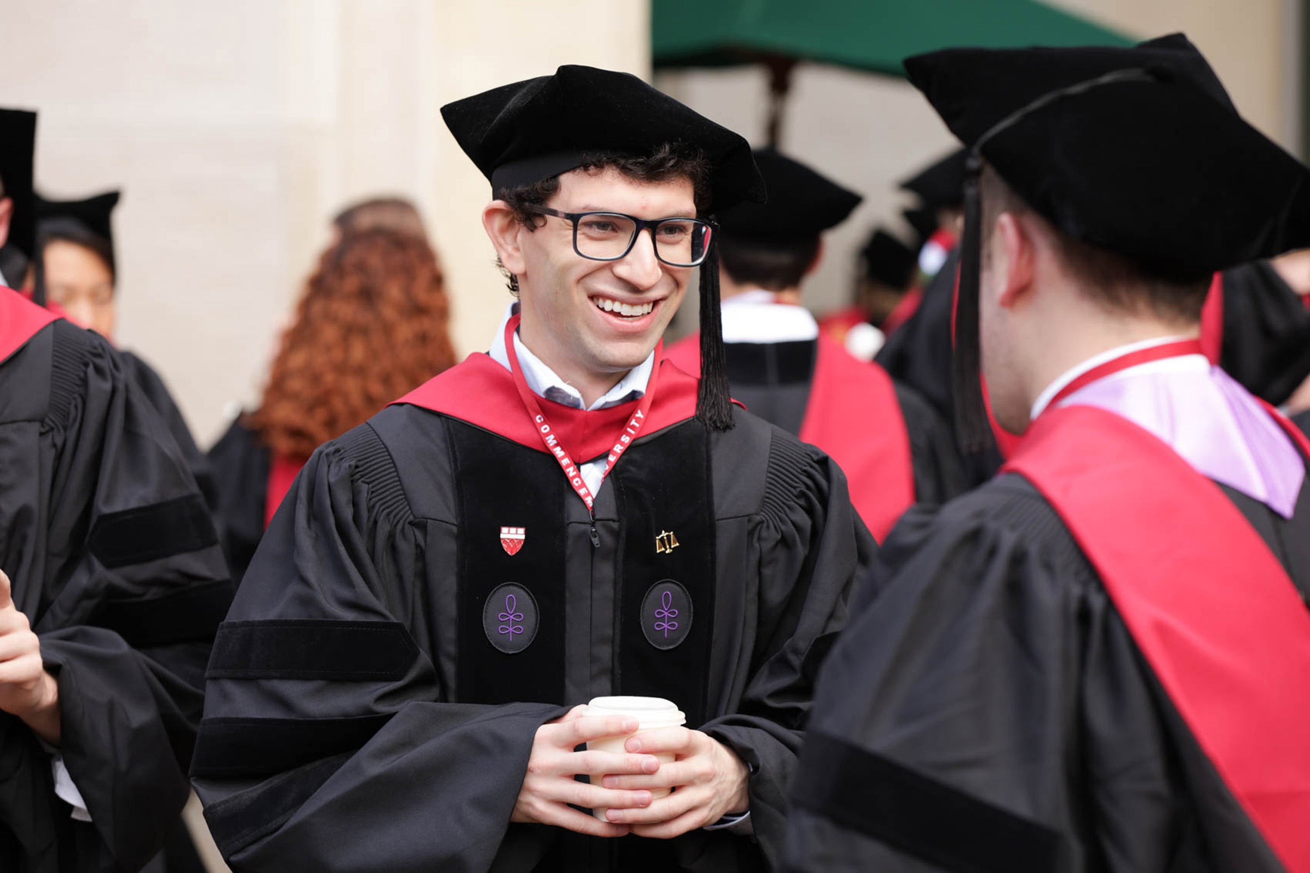 Two men in regalia converse