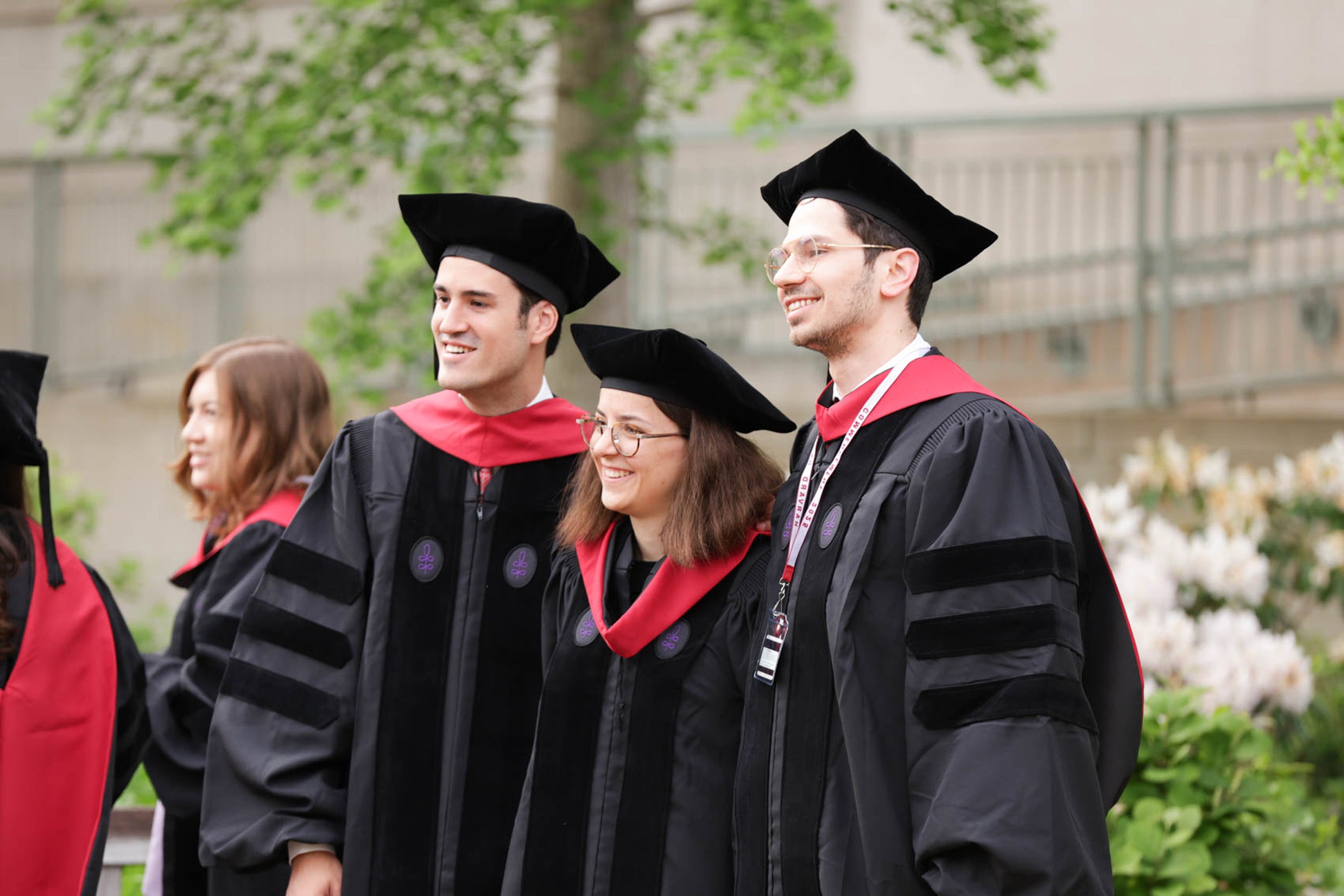 Three graduates pose for photo
