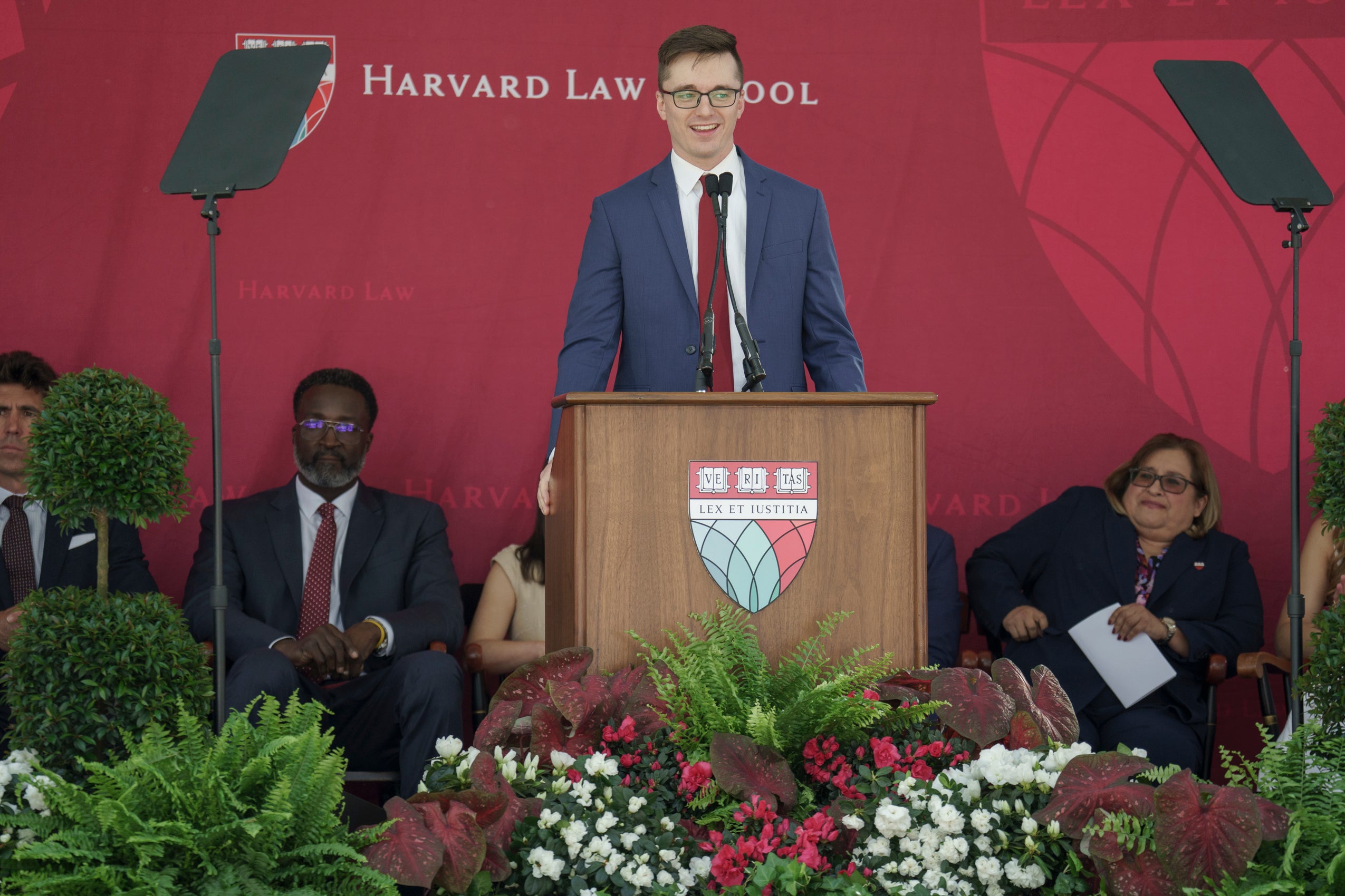 A man standing and speaking at a podium