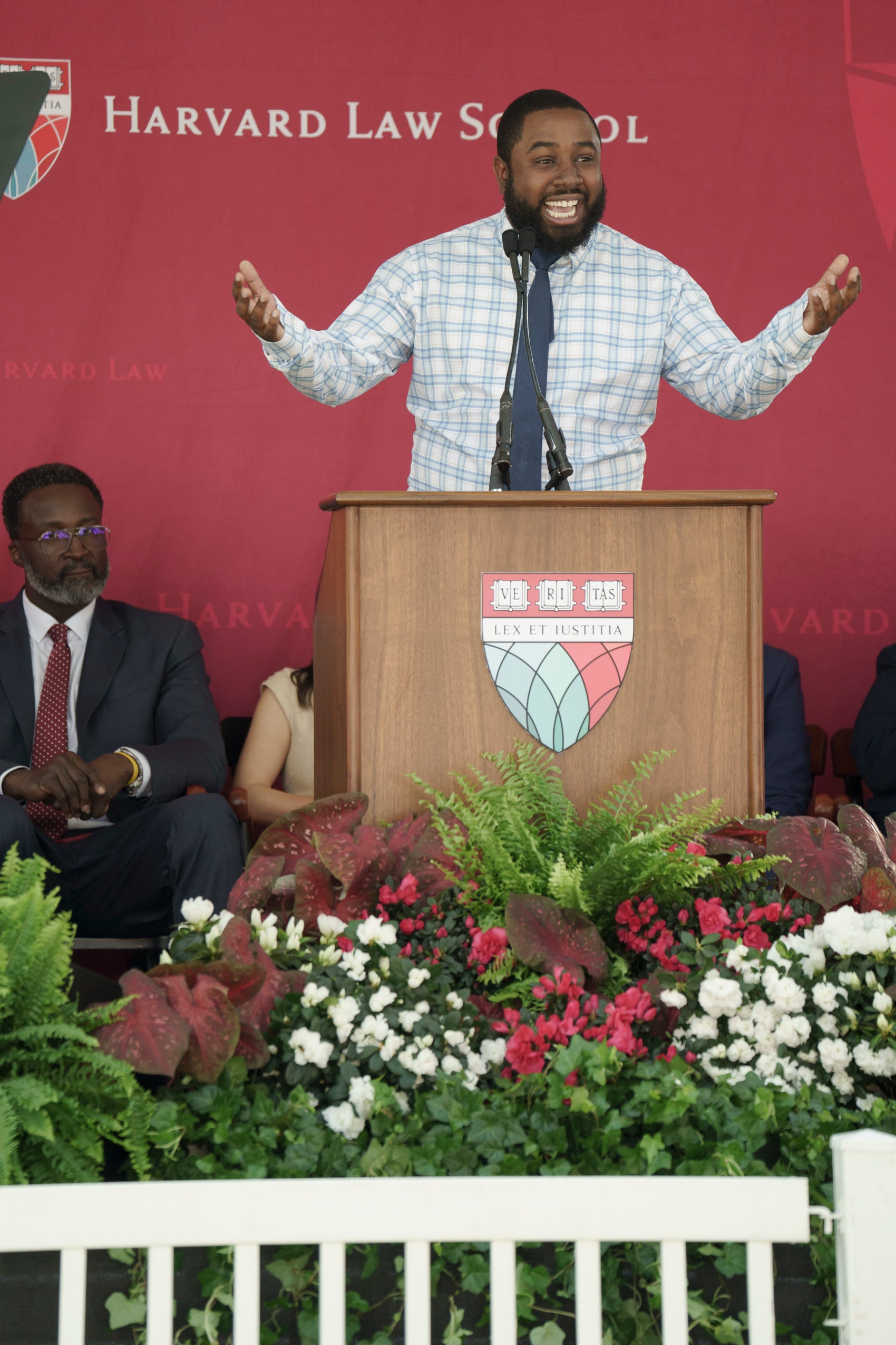 A man standing and speaking at a podium