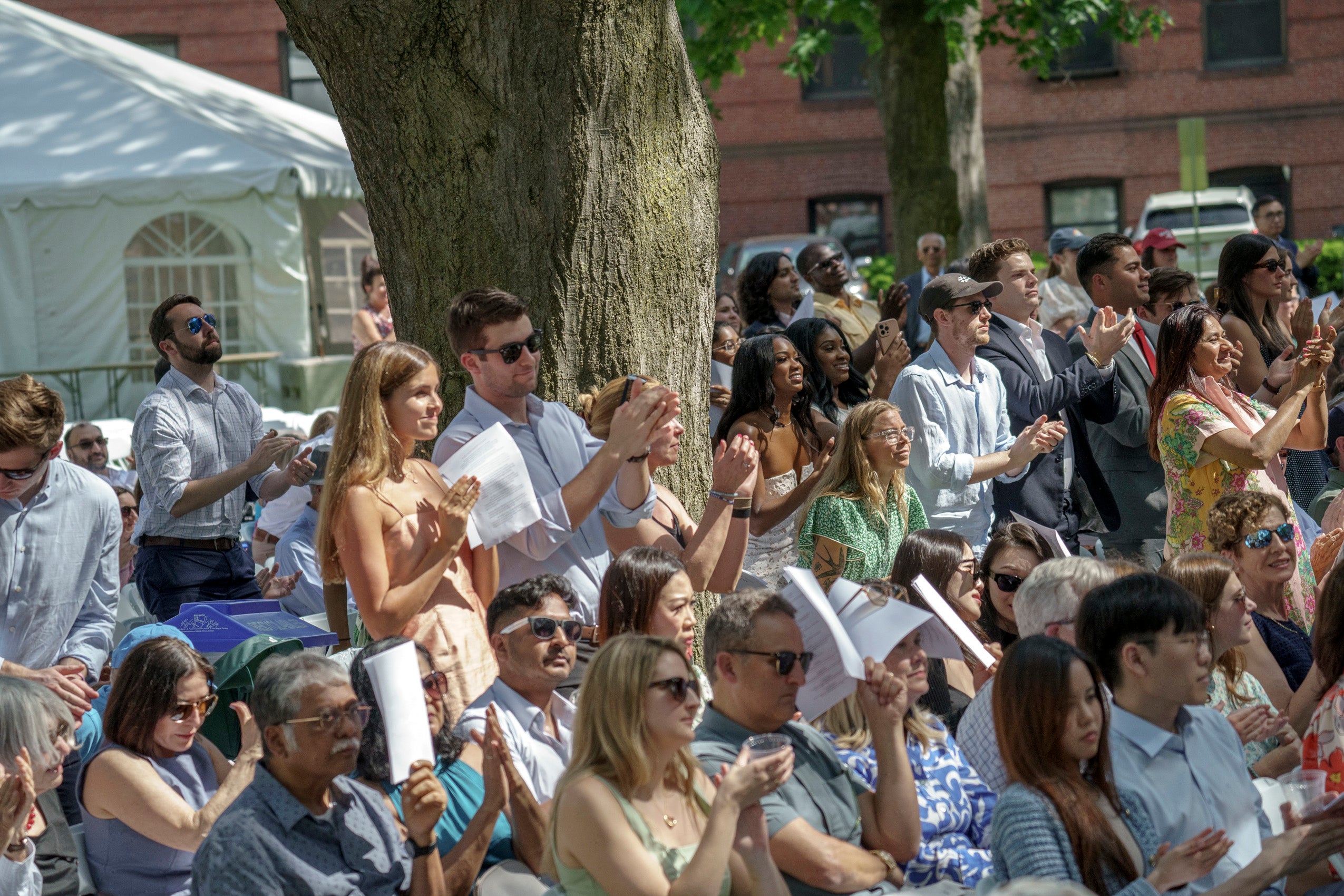 An audience standing and applauding