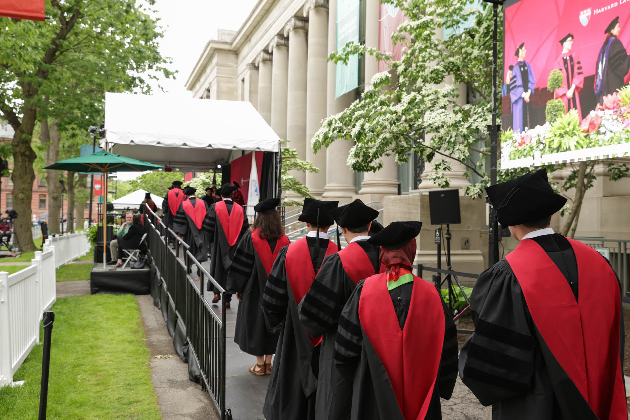 Graduates lining up on stage to receive their diplomas