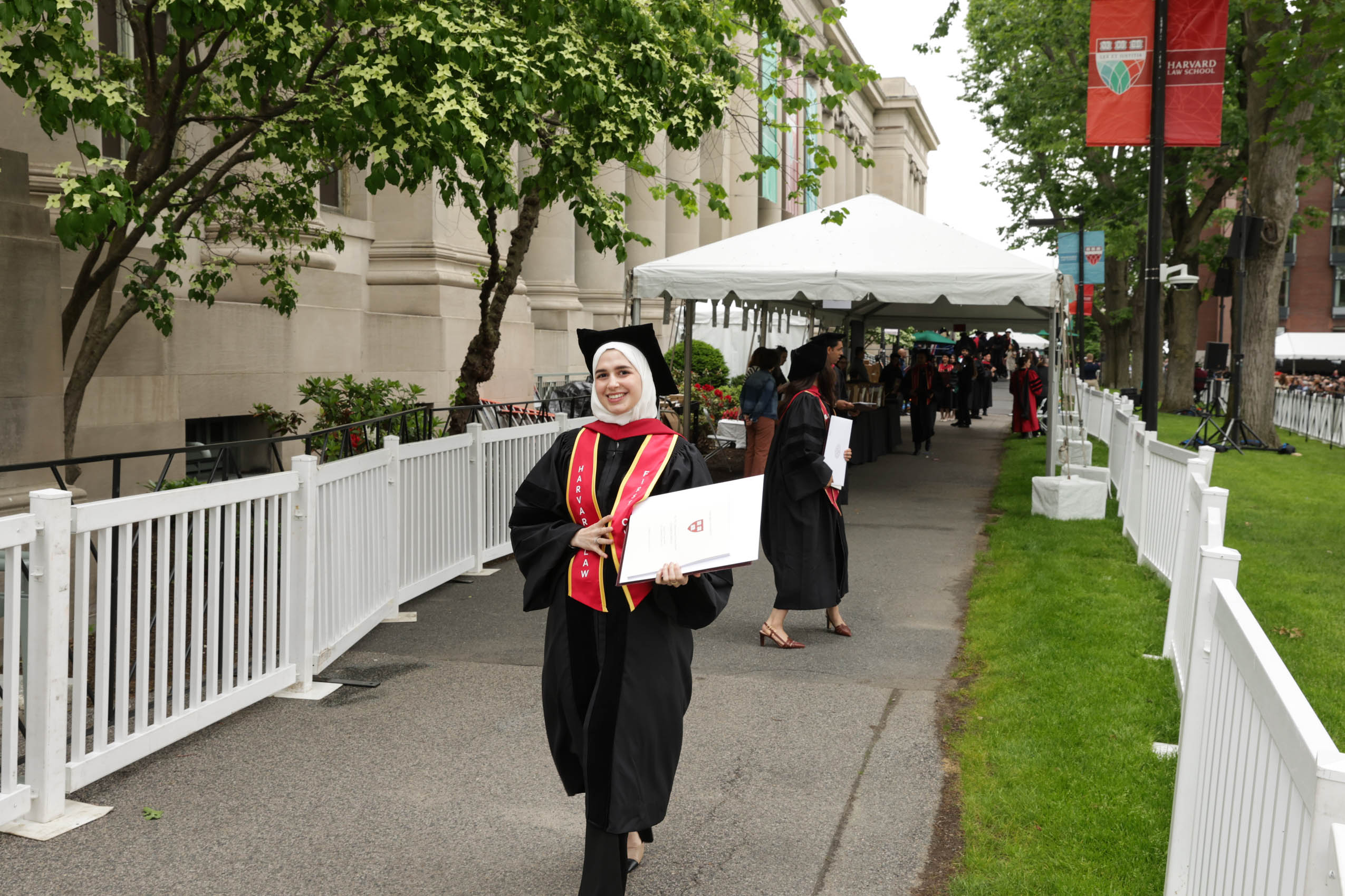 A graduate holding her diploma