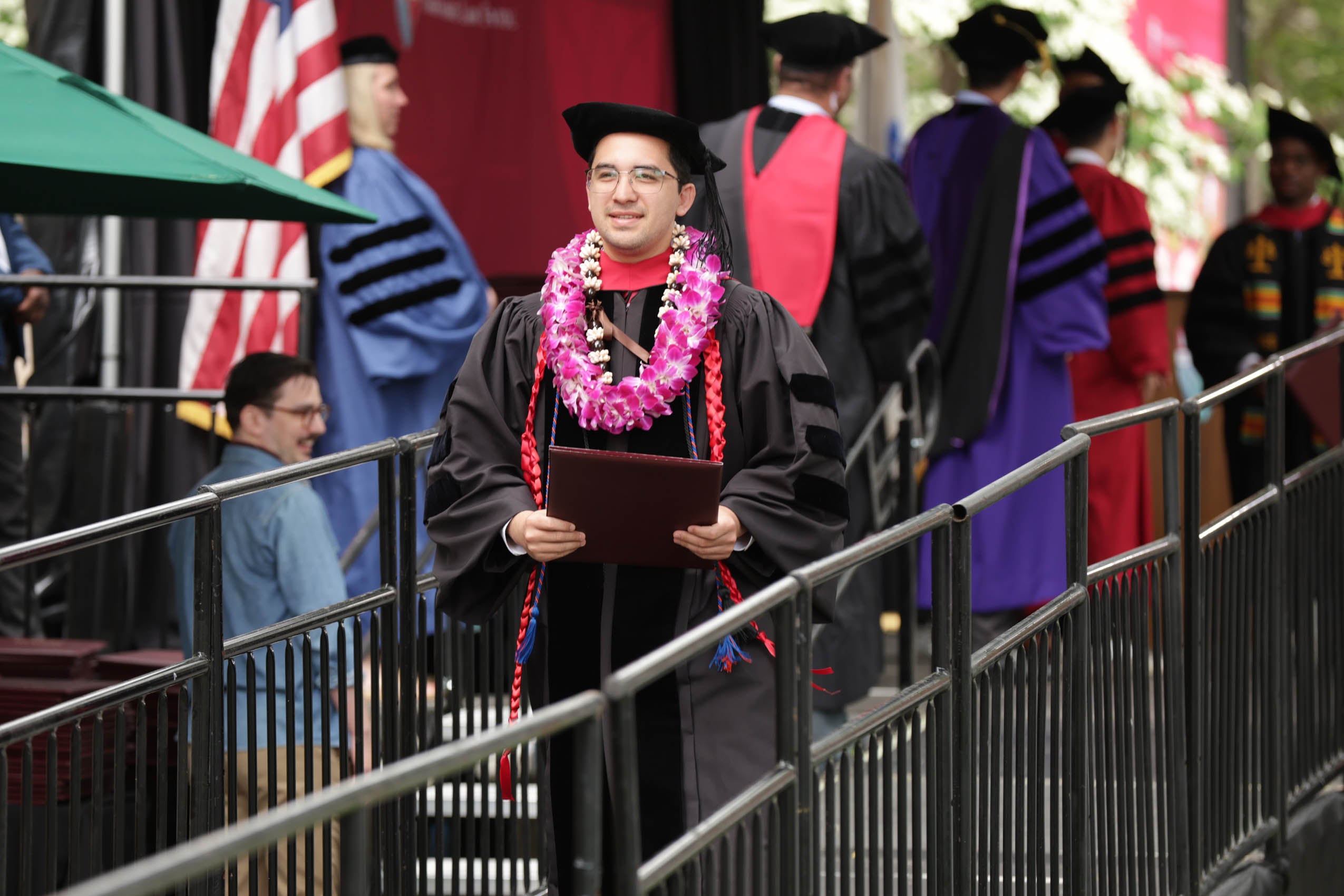 A graduate holding his degree