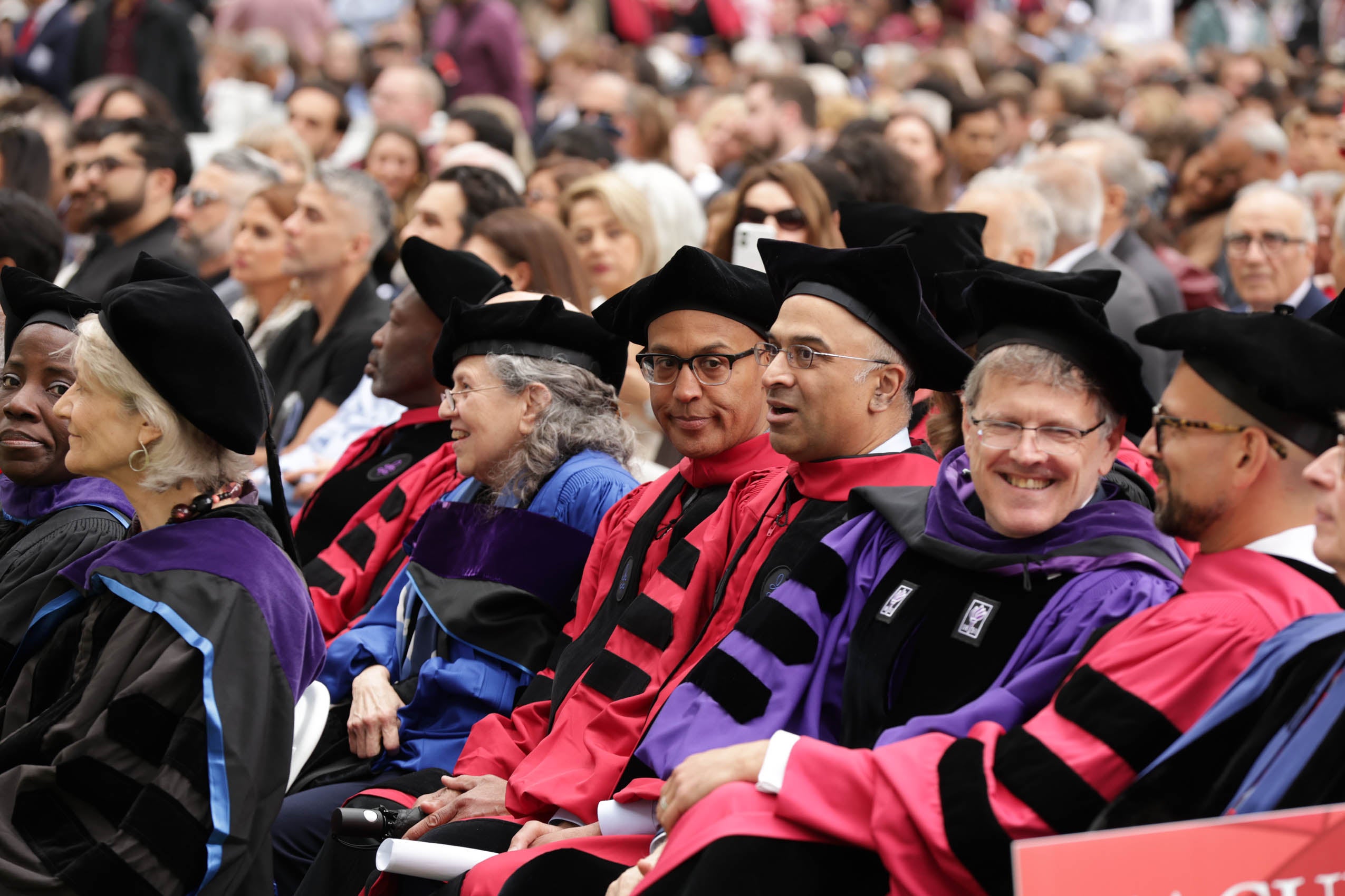 Faculty sitting and listening to the program