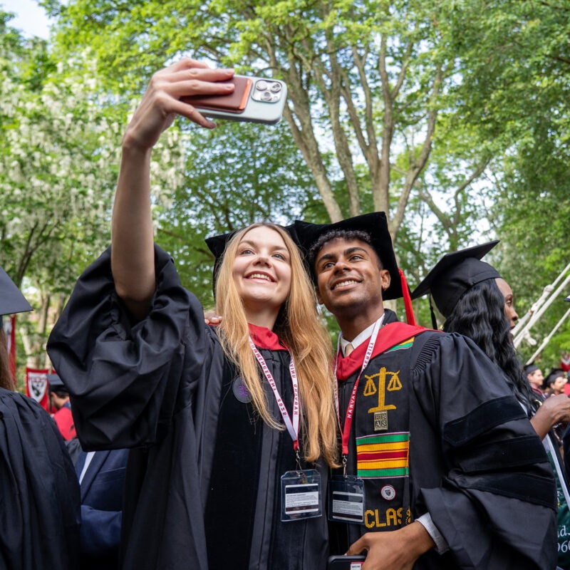 Two graduates taking a selfie.