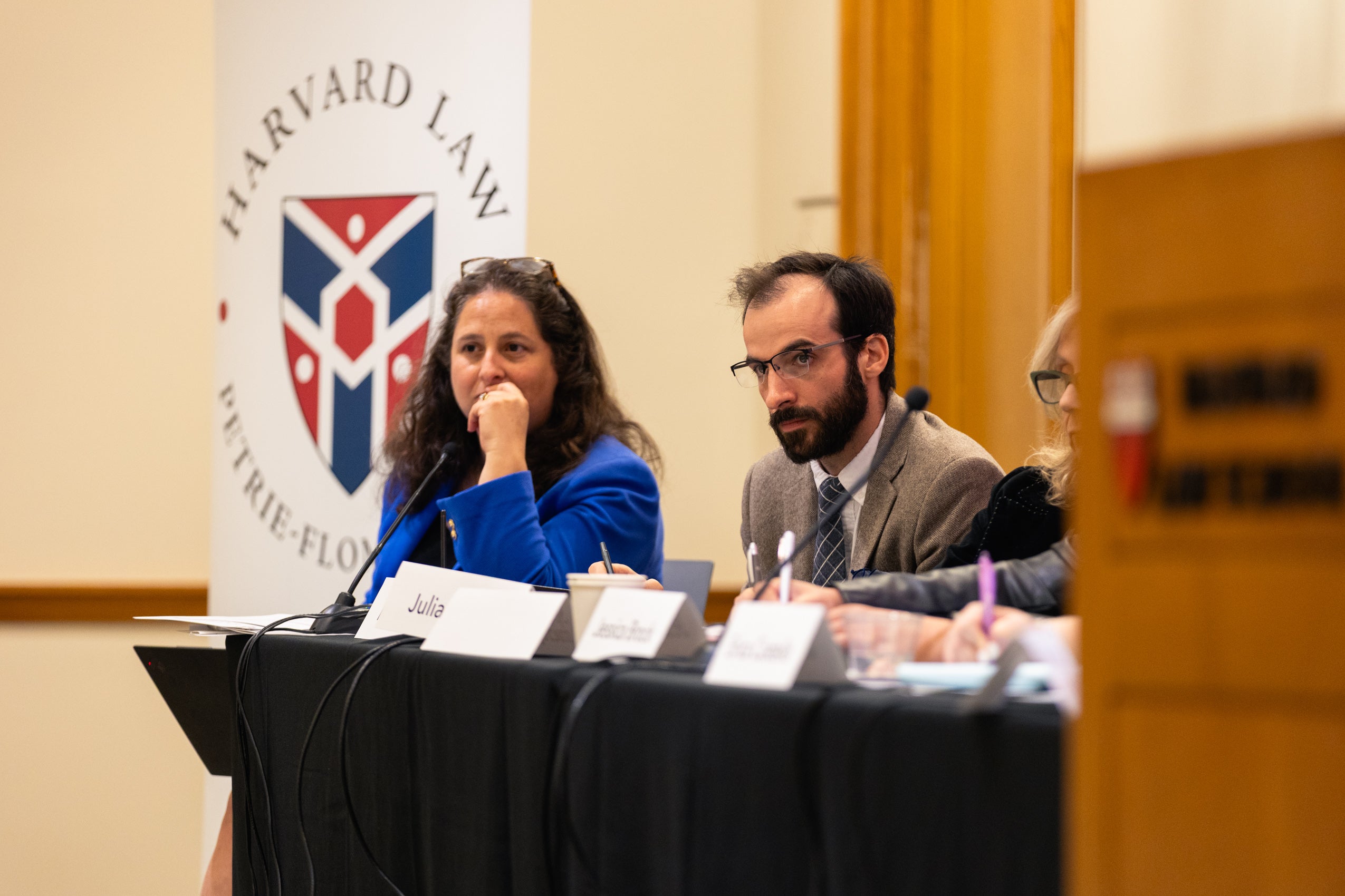 Two panelists seated at a table.