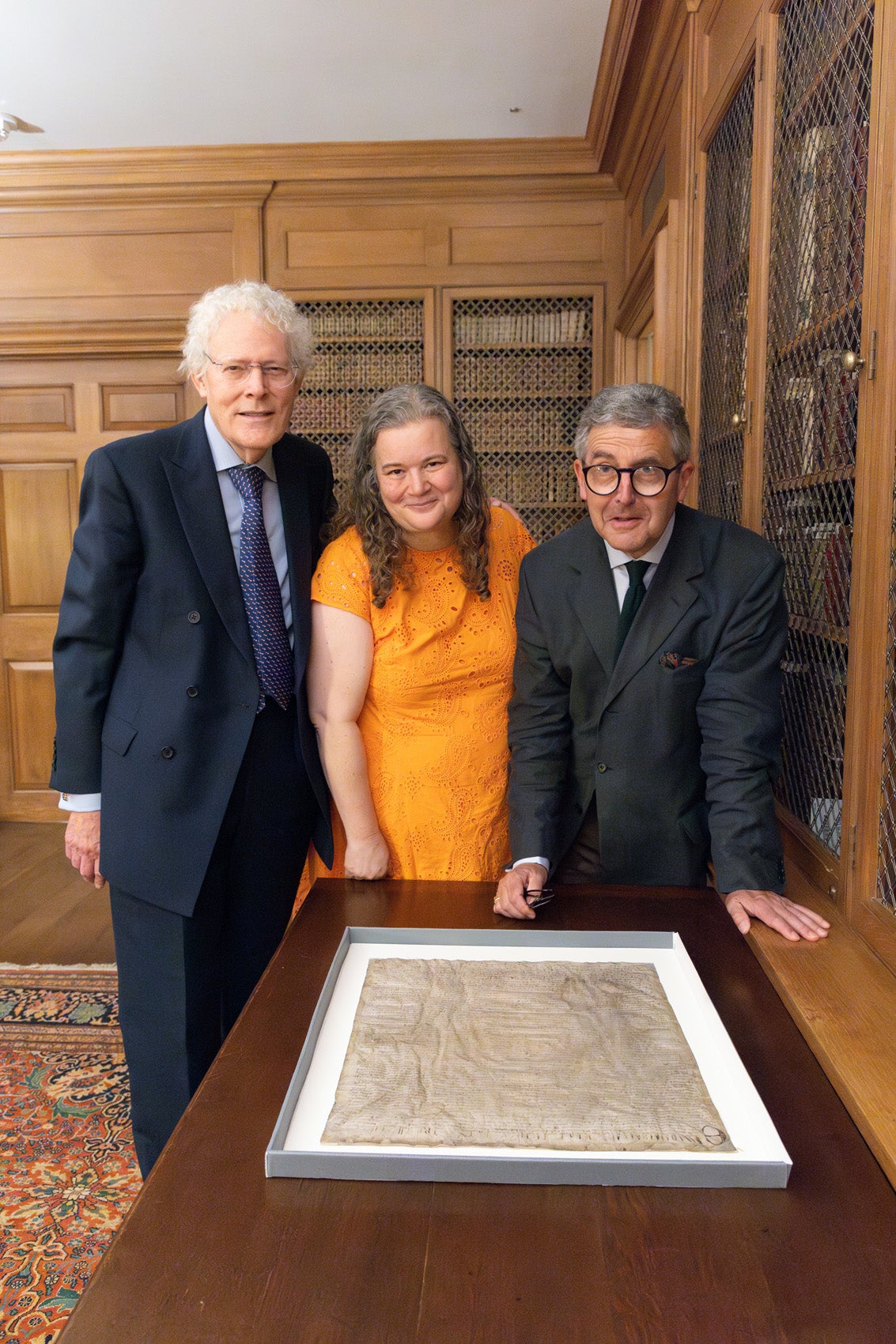 British researchers David Carpenter and Nicholas Vincent pose with Amanda Watson of the Harvard Law School Library during their to visit to view the Magna Carta at Harvard University’s Houghton Library.