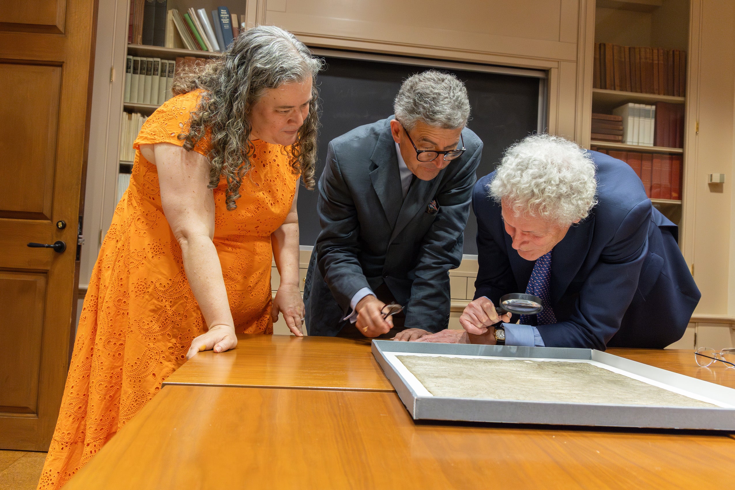 British researchers, David Carpenter and Nicholas Vincent look closely at the the Magna Carta at Harvard University’s Houghton Library with Amanda Watson from Harvard Law School's Library.
