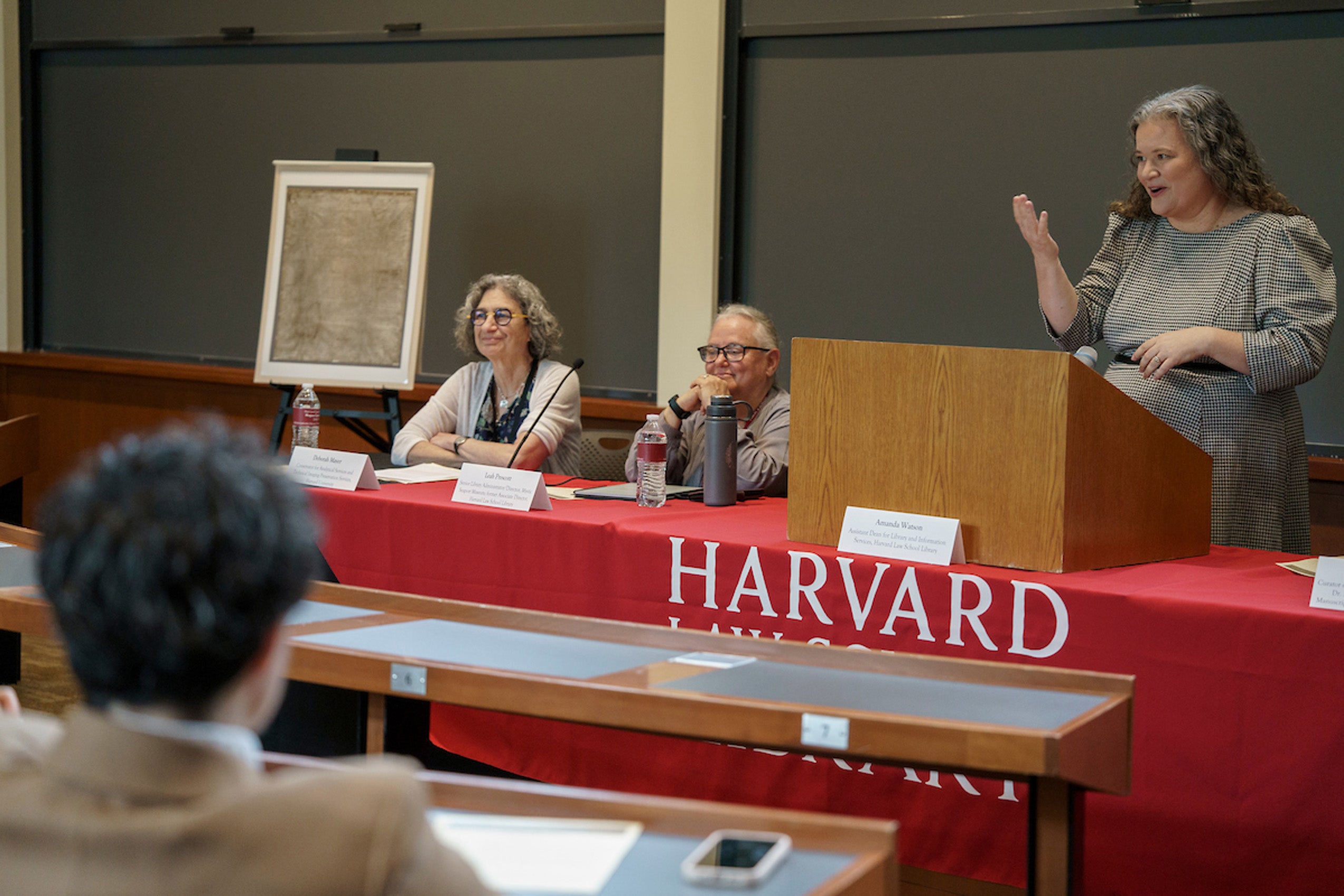 A woman speaks on a panel.