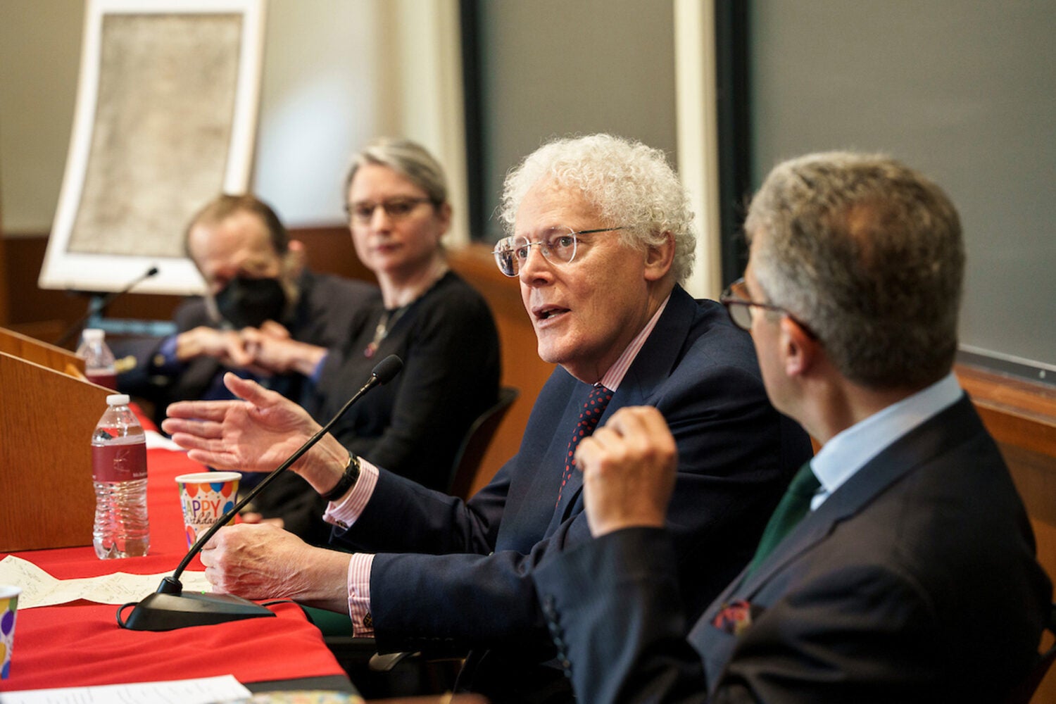 Panelists speak at an event.