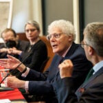 Panelists speak at an event.
