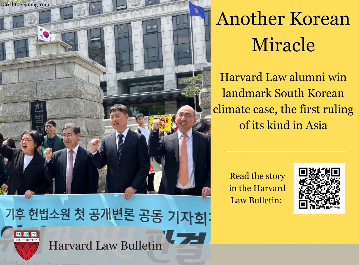 People holding a sign in Korea with promotional text about Harvard Law Bulletin story