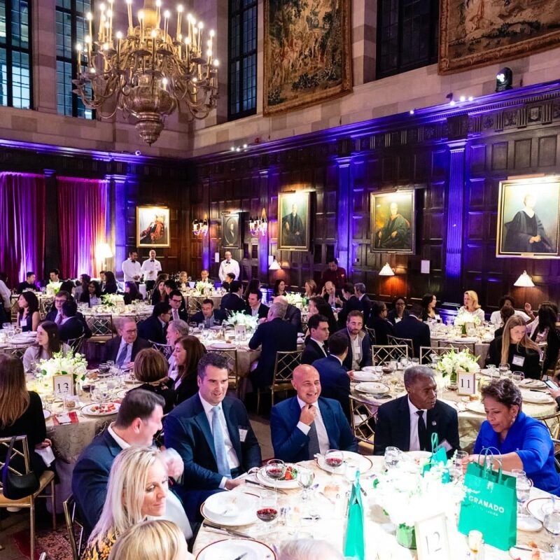 Members of the HLSA of Europe having dinner in a large ballroom.
