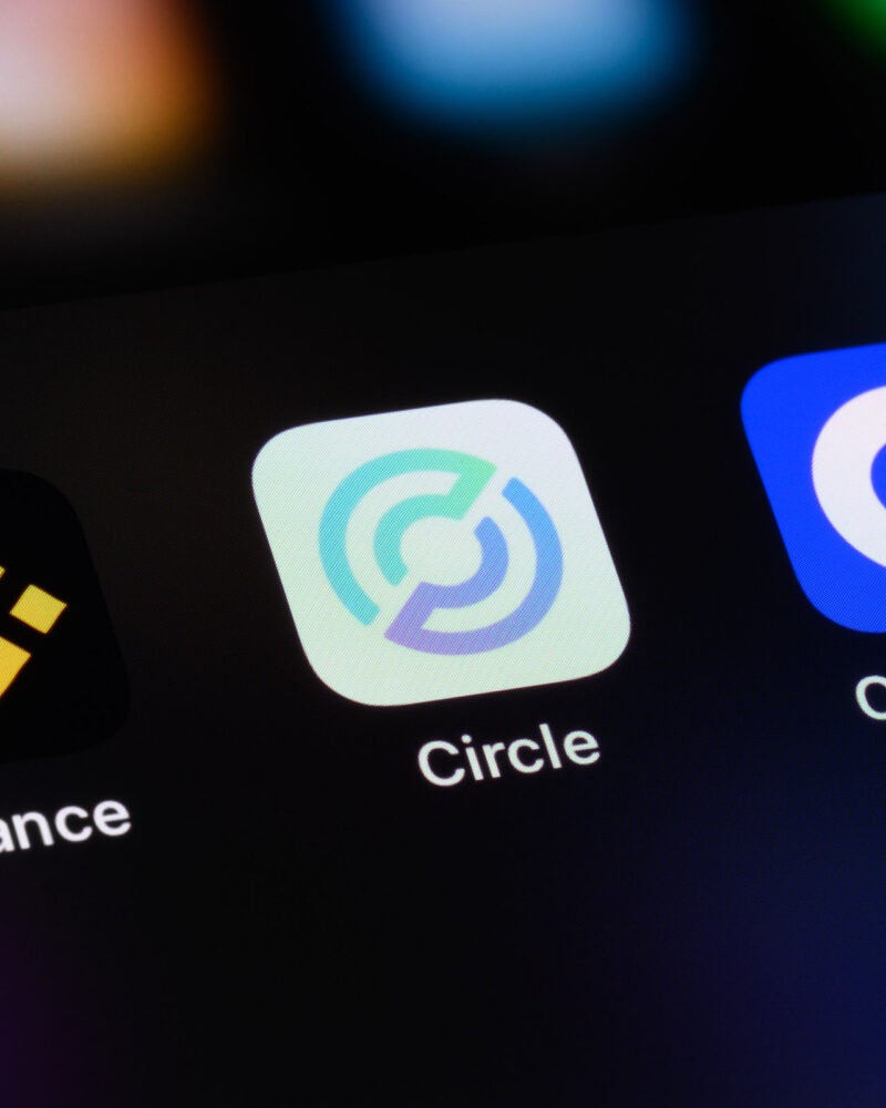 Cryptocurrency trading apps on a mobile phone screen.