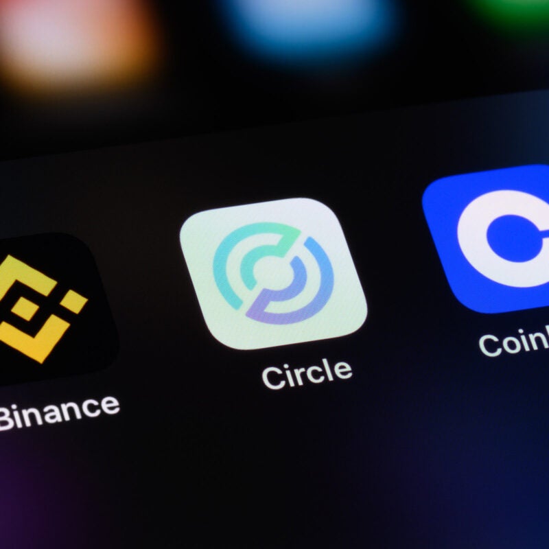 Cryptocurrency trading apps on a mobile phone screen.