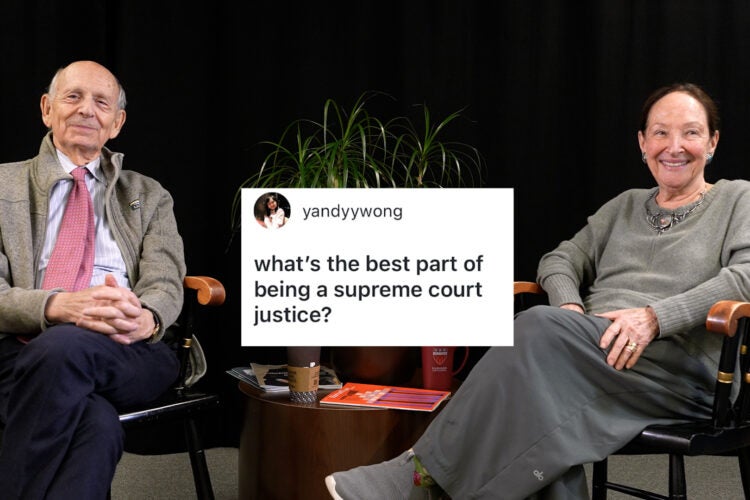 A video still showing Justices Breyer and Abella sat in wooden seats in front of a black backdrop. A screenshot in front of them shows a question from a social media follower reading, 