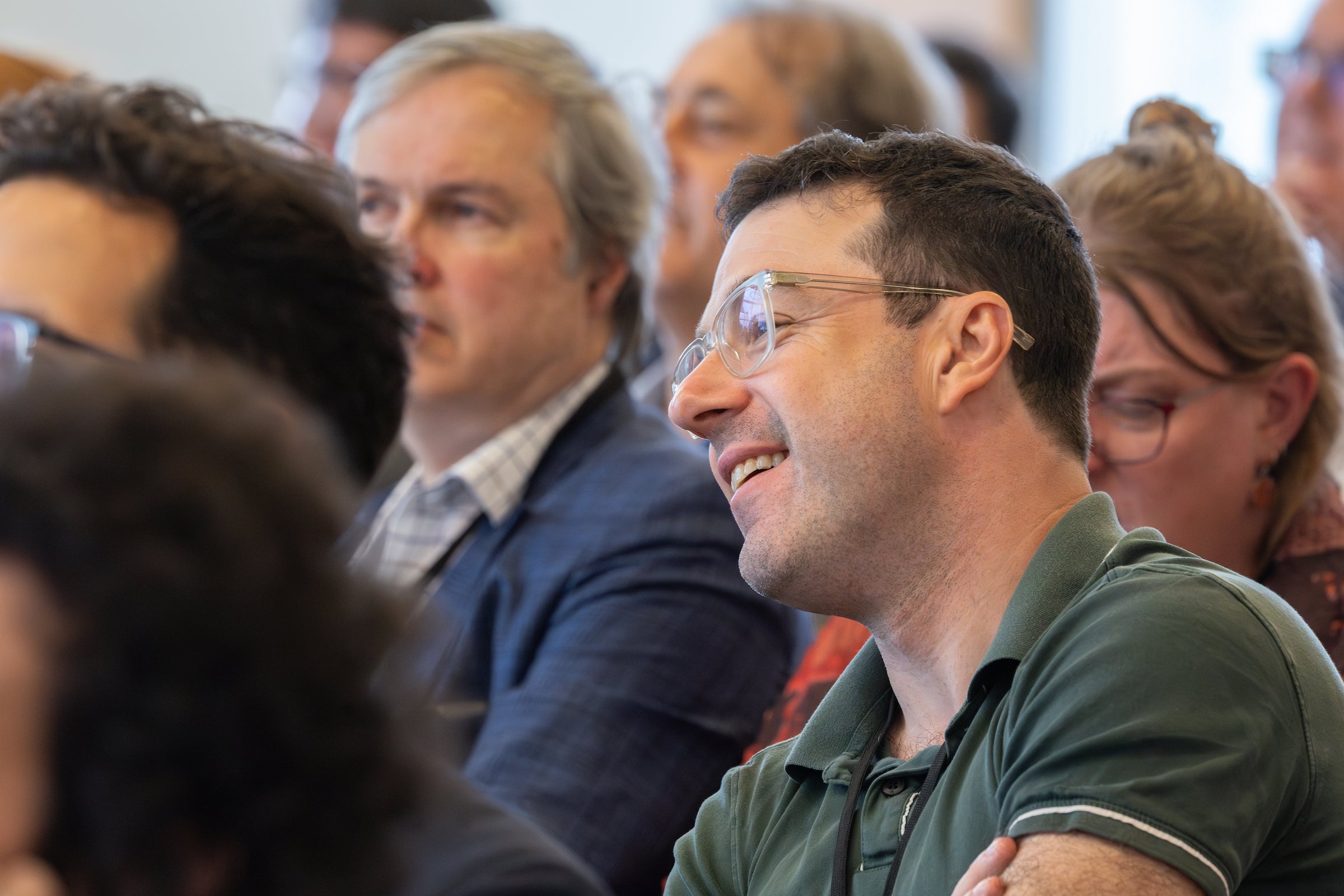 Obligations Conference attendees watching a panel discussion.