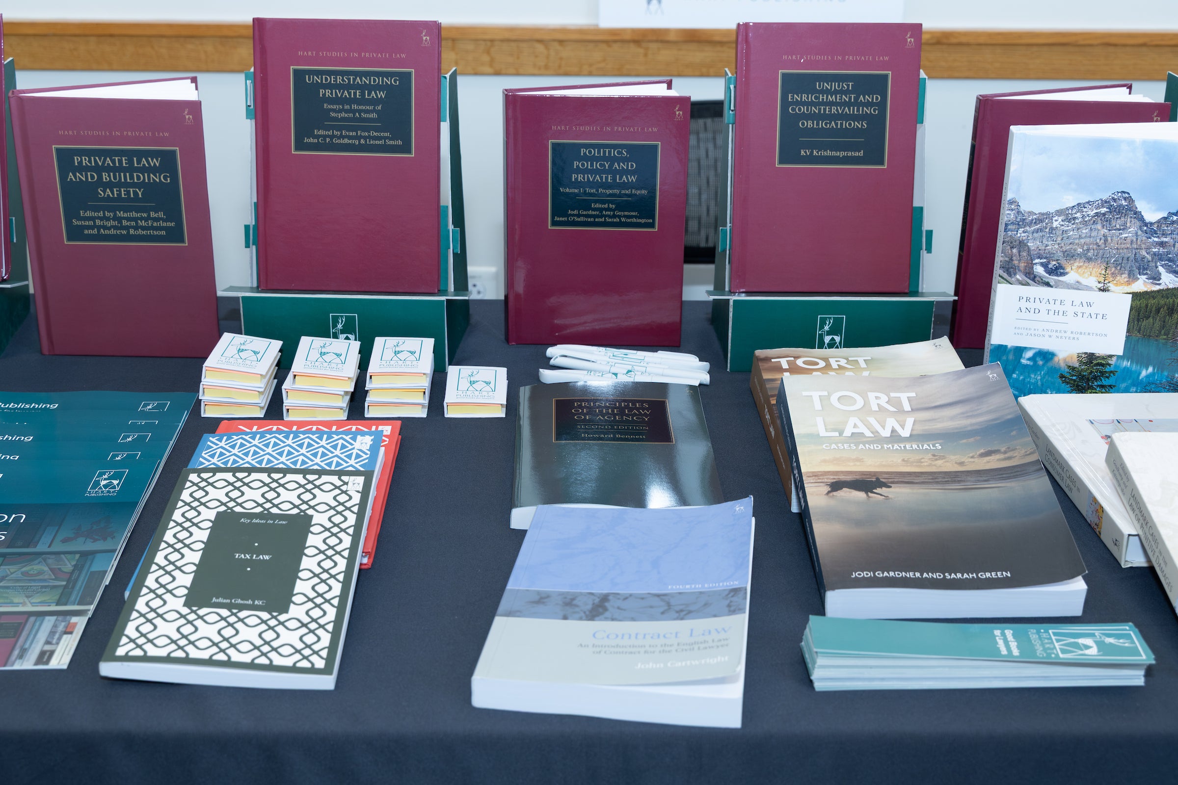 Books on various aspects of private law displayed on a table.