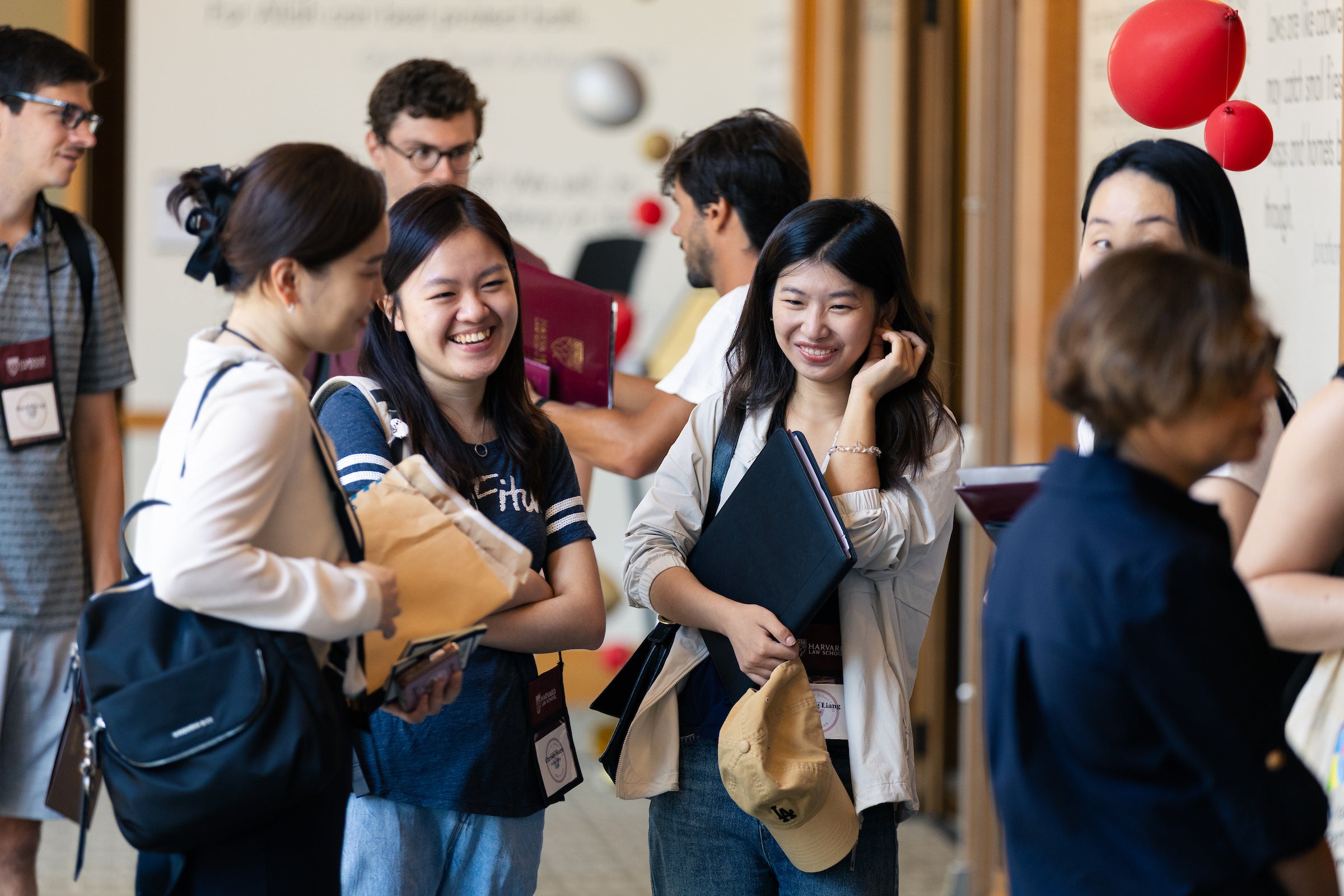 Students share a light moment in the hallway during LL.M. orientation.
