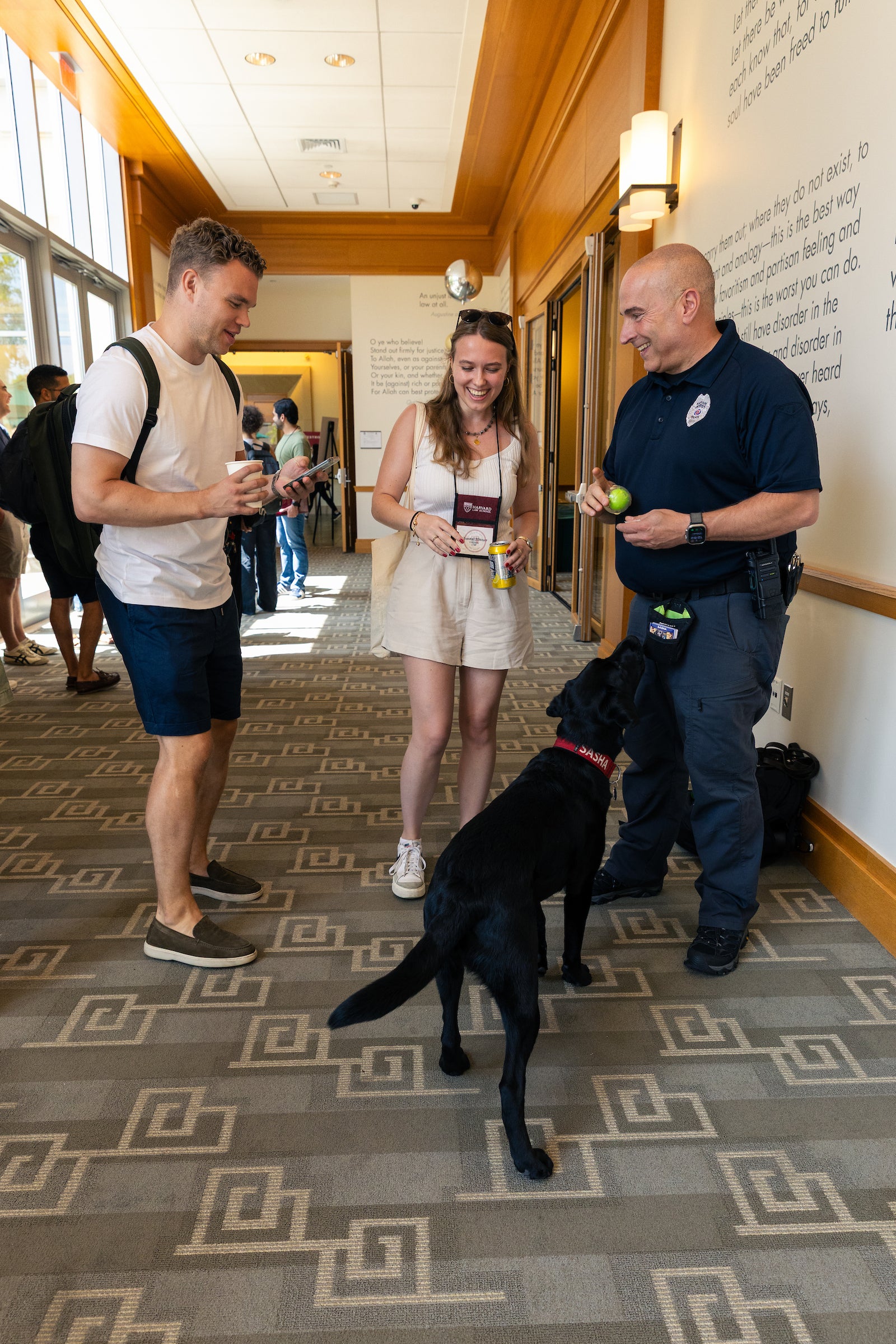 Students a visit with Sasha the HUPD Community Engagement Dog at orientation.