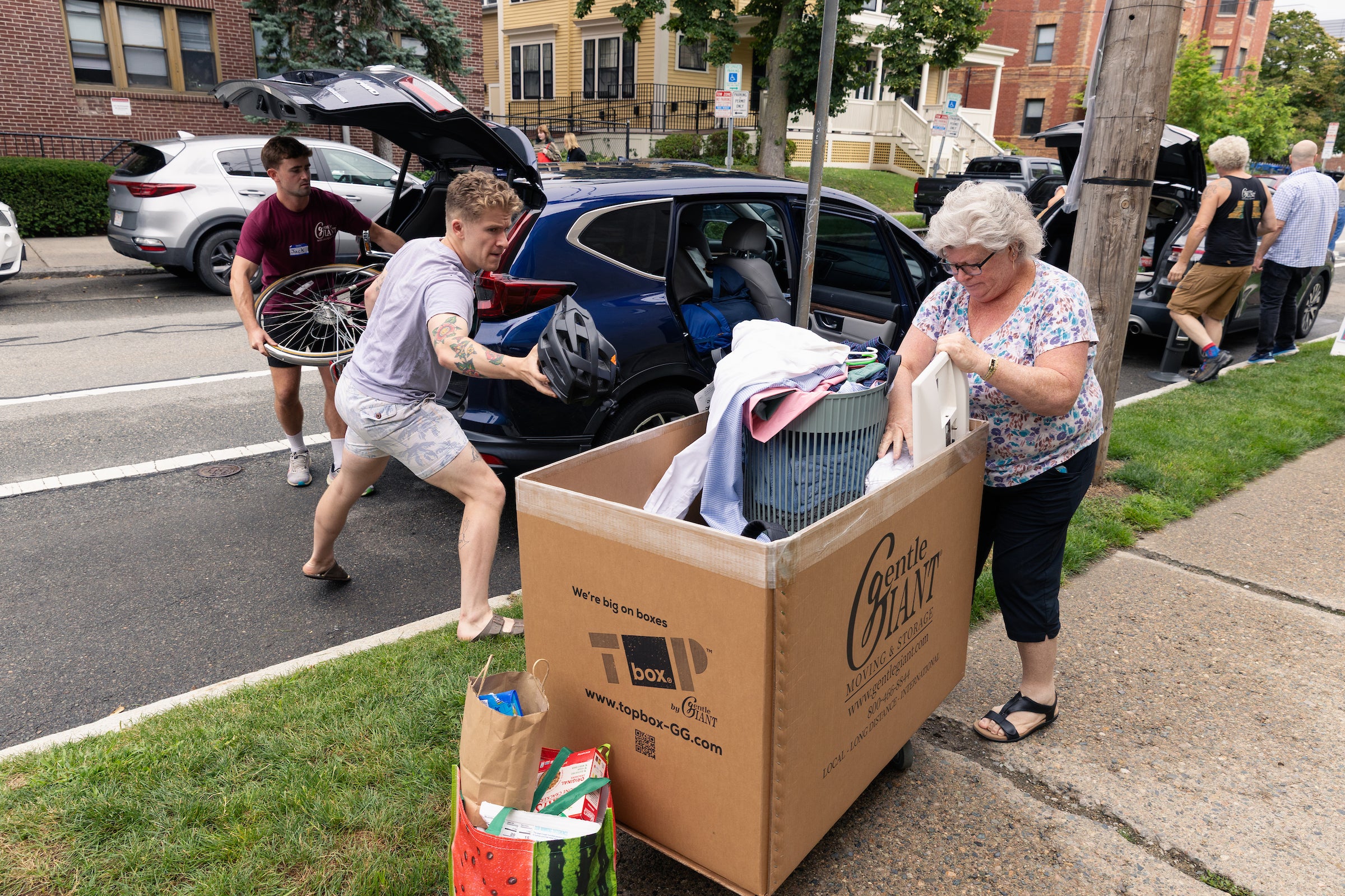 A student unloads his car during move-in day.