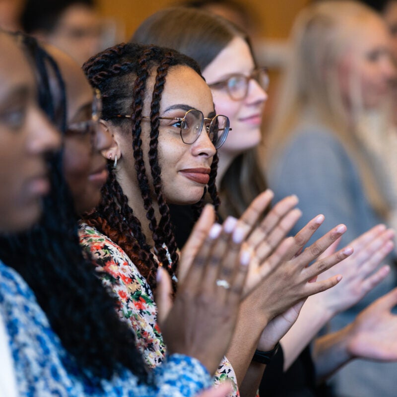 Attendees applaud at the First Class welcome reception.
