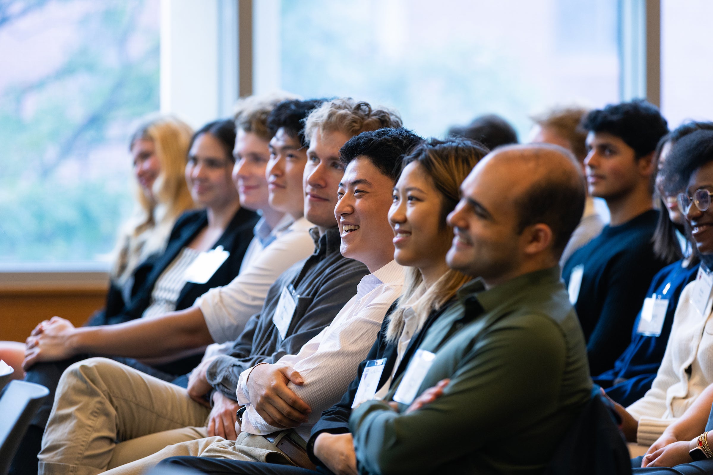 A close up of several rows of students enjoying remarks during an event for first class students held during orientation.