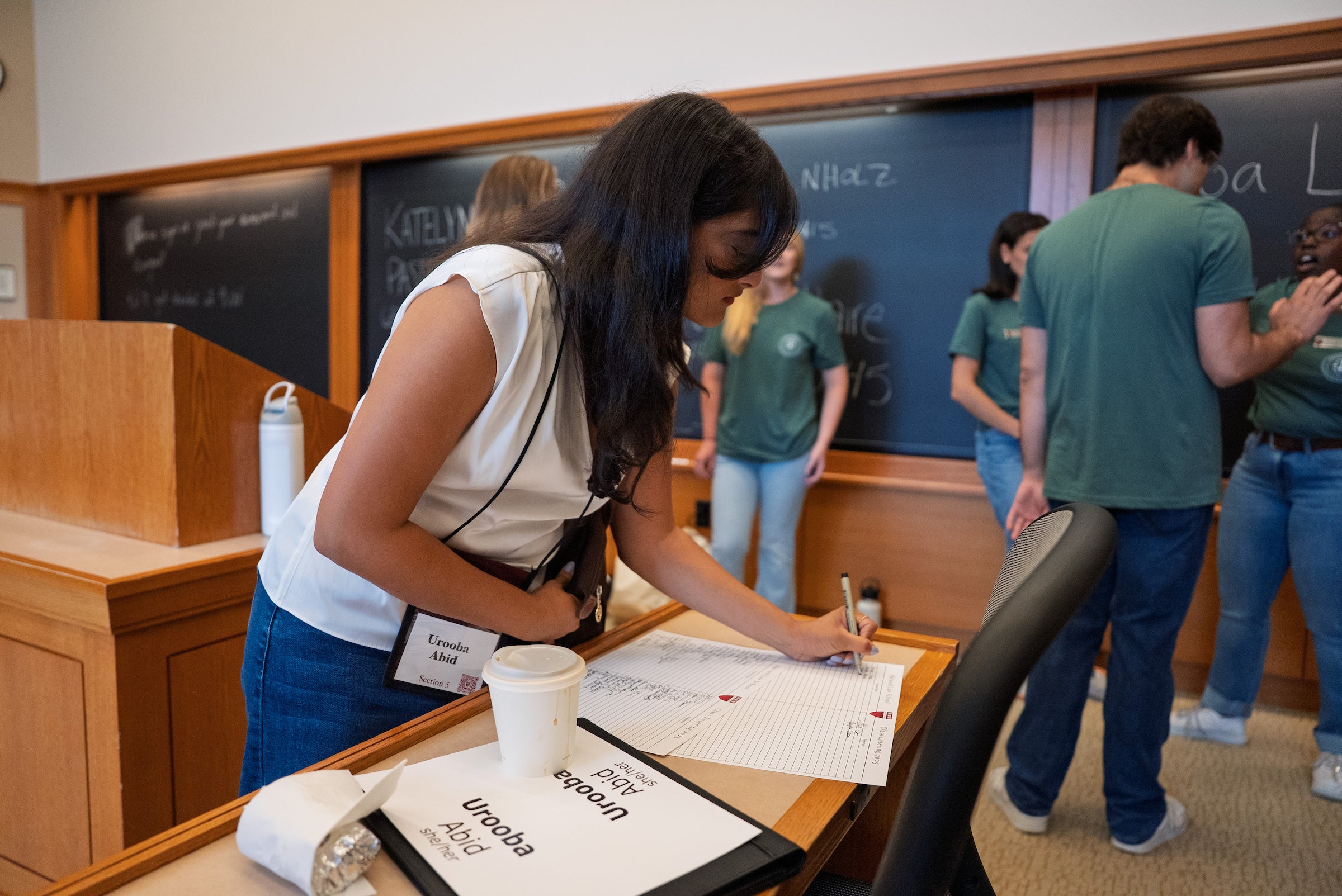 A student signs in during orientation.