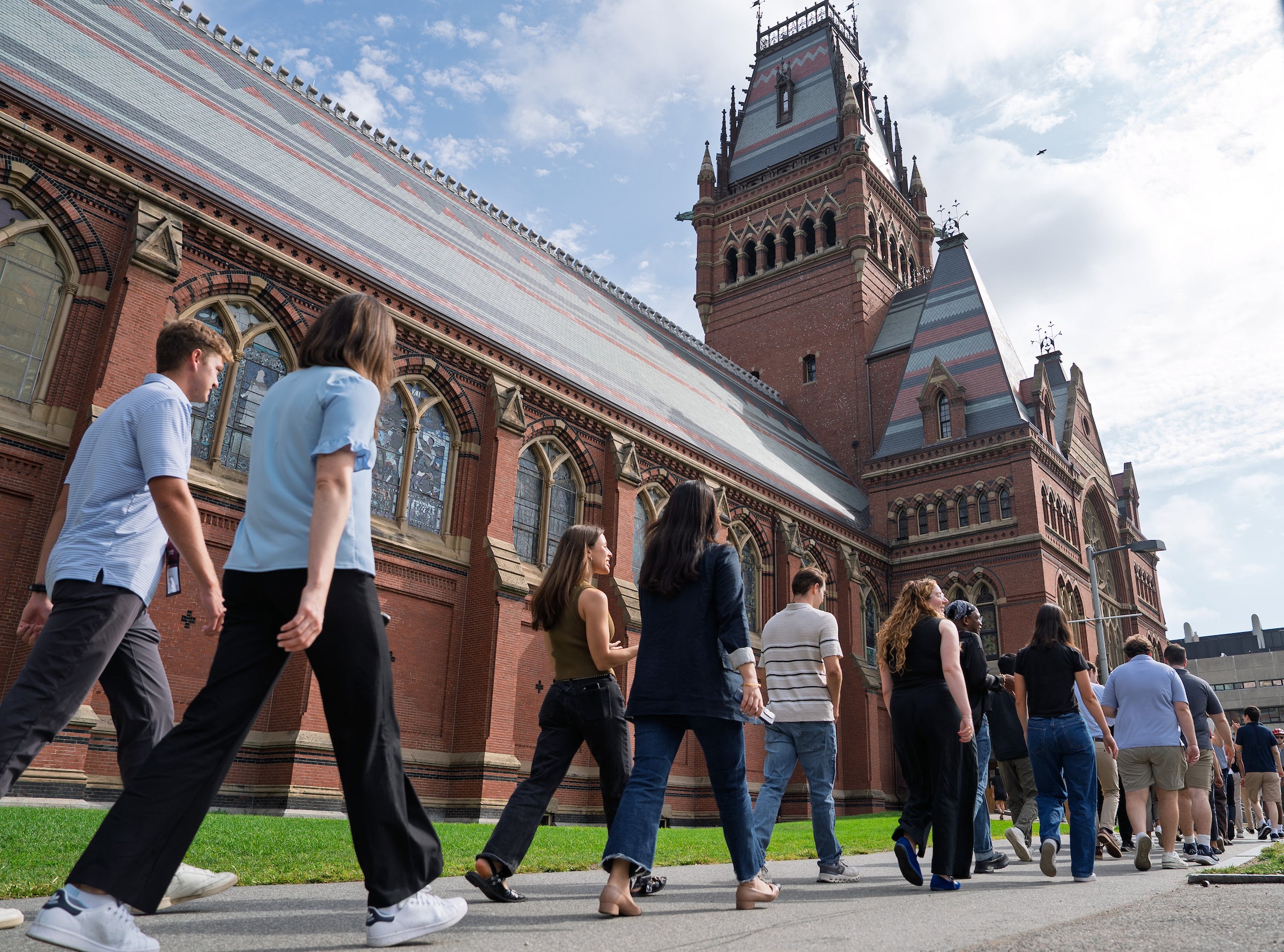 Students walk along the side of Memorial Hall on their way to Sanders Theatre for an orientation event.