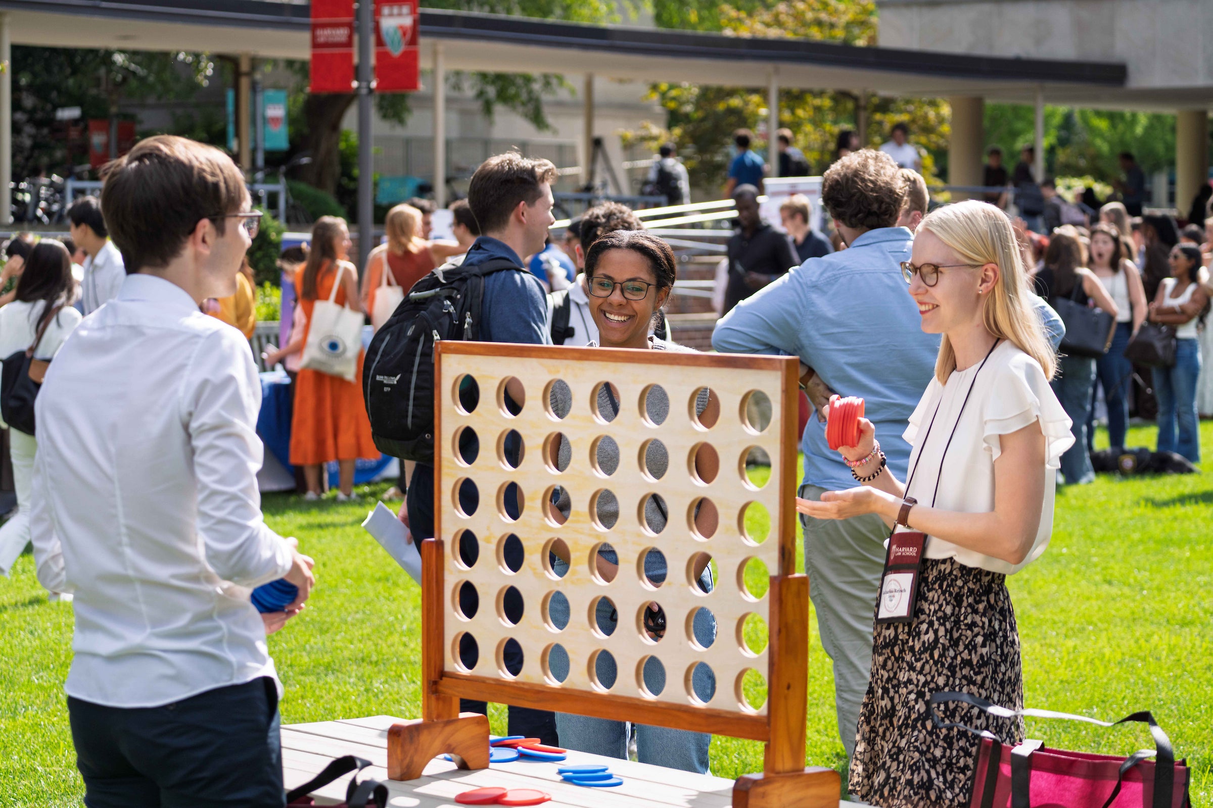 Students play a game on the lawn of campus during an orientation event.
