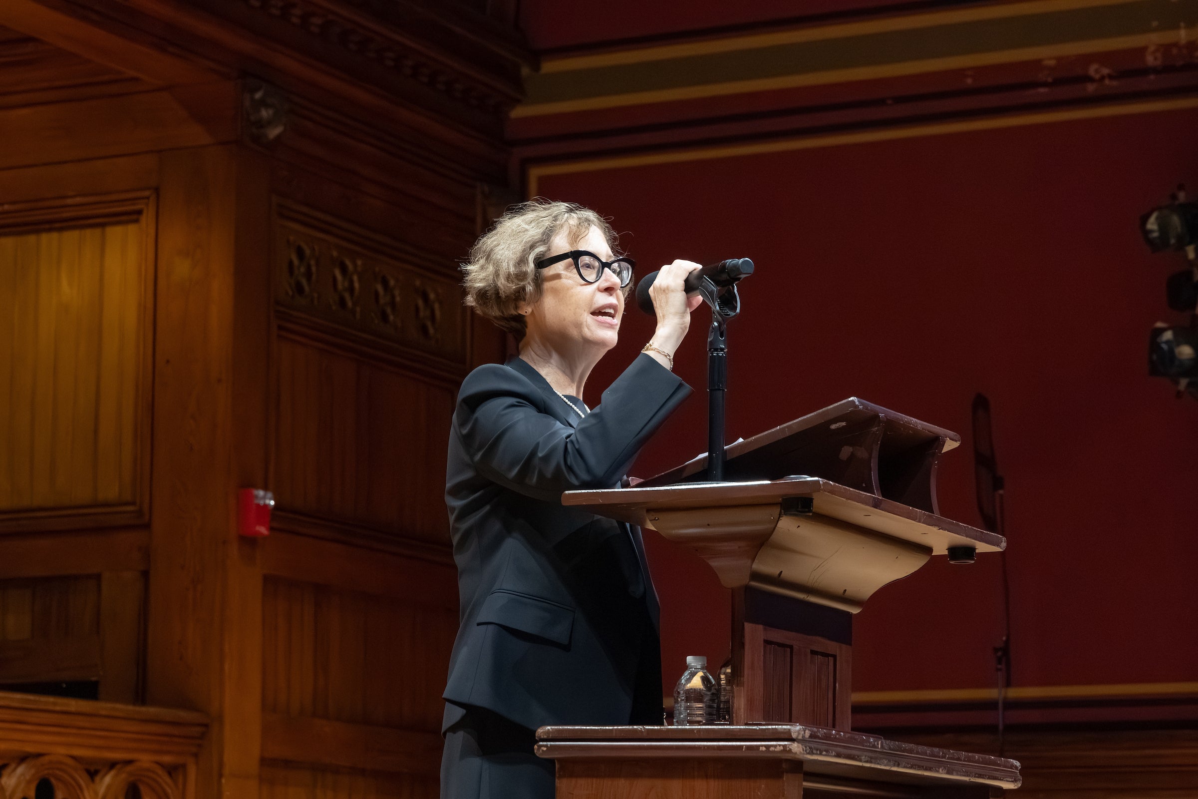 Nancy Pinn speaking at a podium.