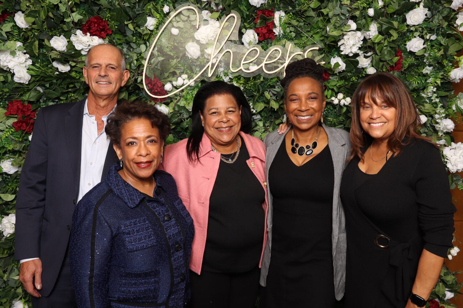 HLS Alumni in front of a floral backdrop.