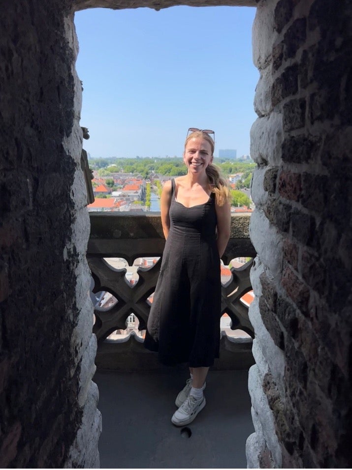 Woman on stone balcony in the Netherlands.