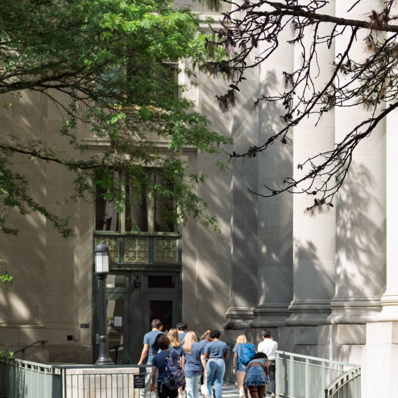 Students walk into Langdell during orientation.